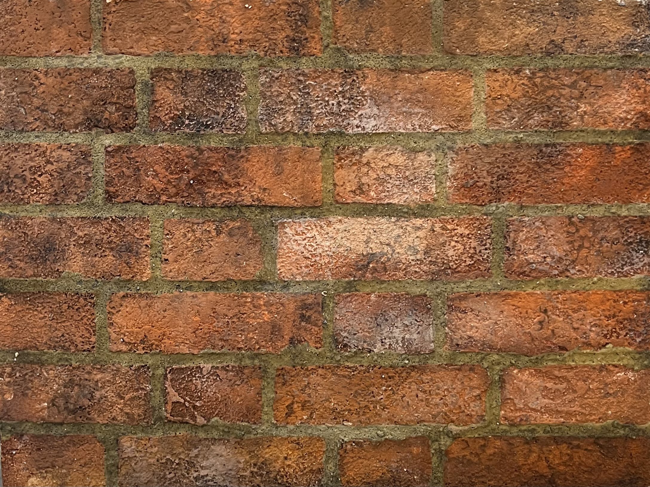 Faux Flemish Bond brick, 18”x24” Masonite, tinted structo-lite, Elmer’s glue with sand and tint, rosco off broadway paint