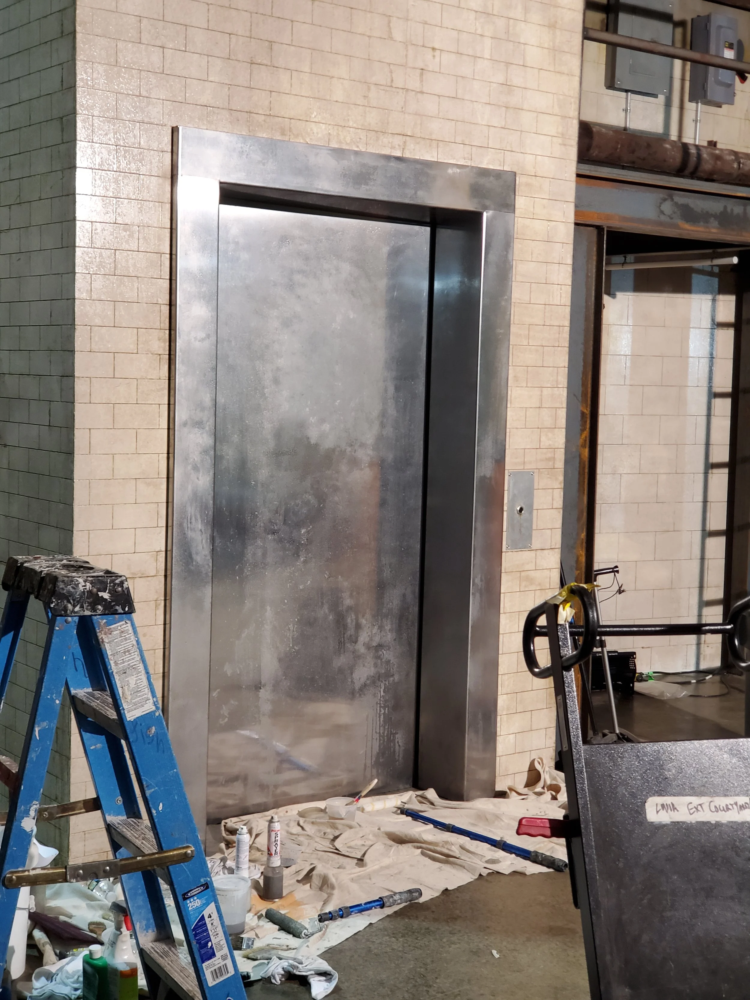 Aged Elevator Doors, pre-val rottenstone and plaster, Subway tiles (did not do the aging) white roof coating, high gloss ben moore