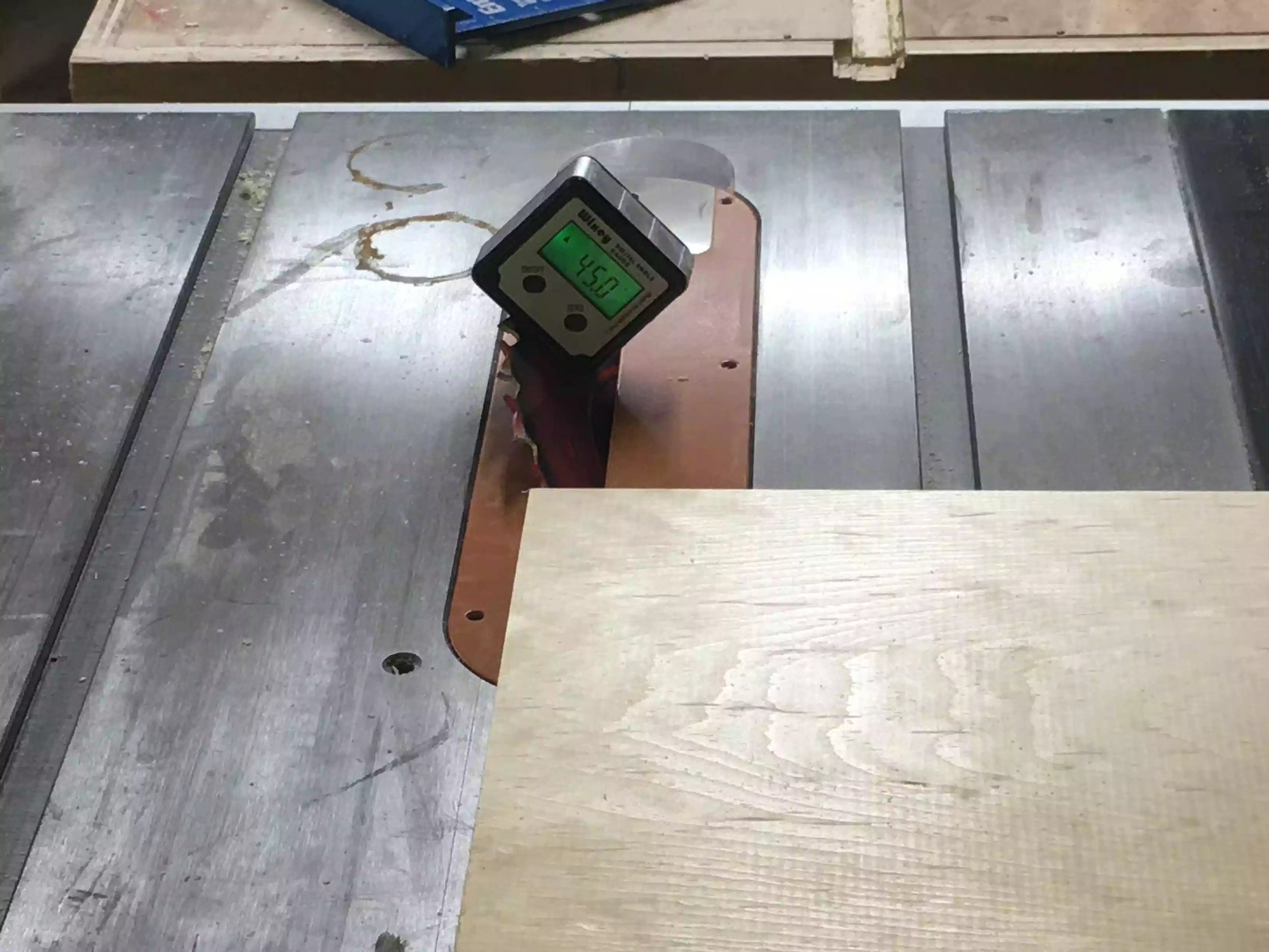 Using my digital angle reader to set my table saw blade at 45 degrees.
