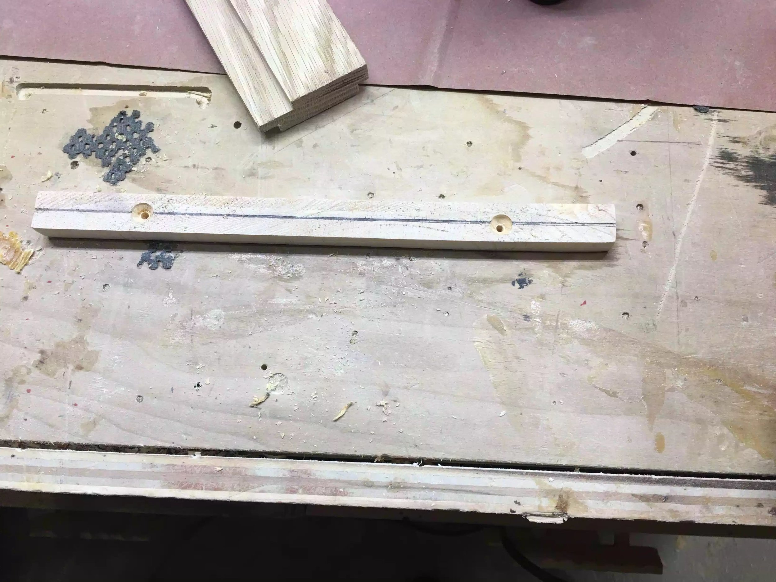 I made this little jig to position the holes in the same place because they would be seen I needed them all to be uniform. Its basically a stick the same size as the shelf dado with a whole placed on each end.
