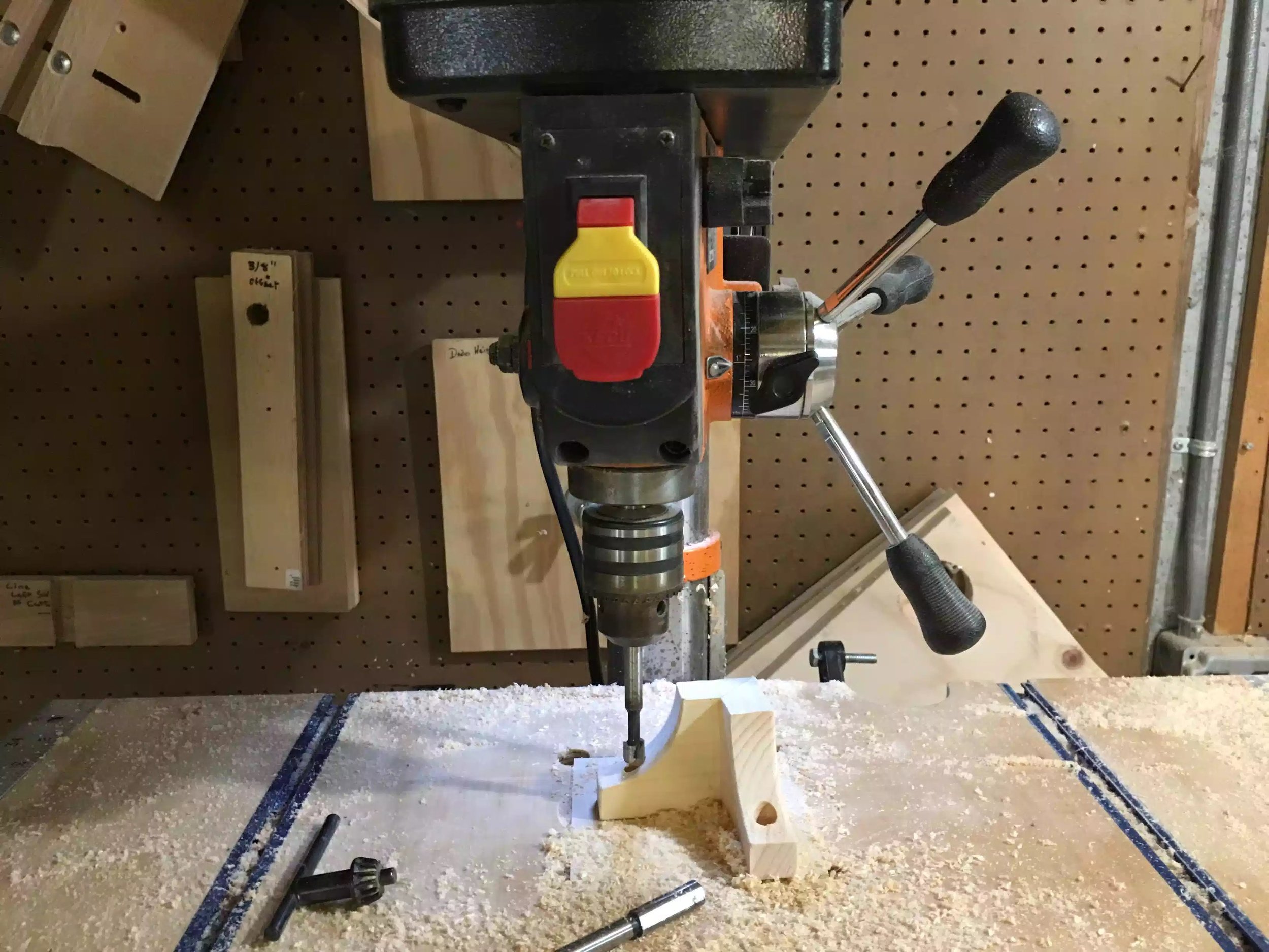 Here is my drill press with a 3/8" forstner bit preparing to drill the hole