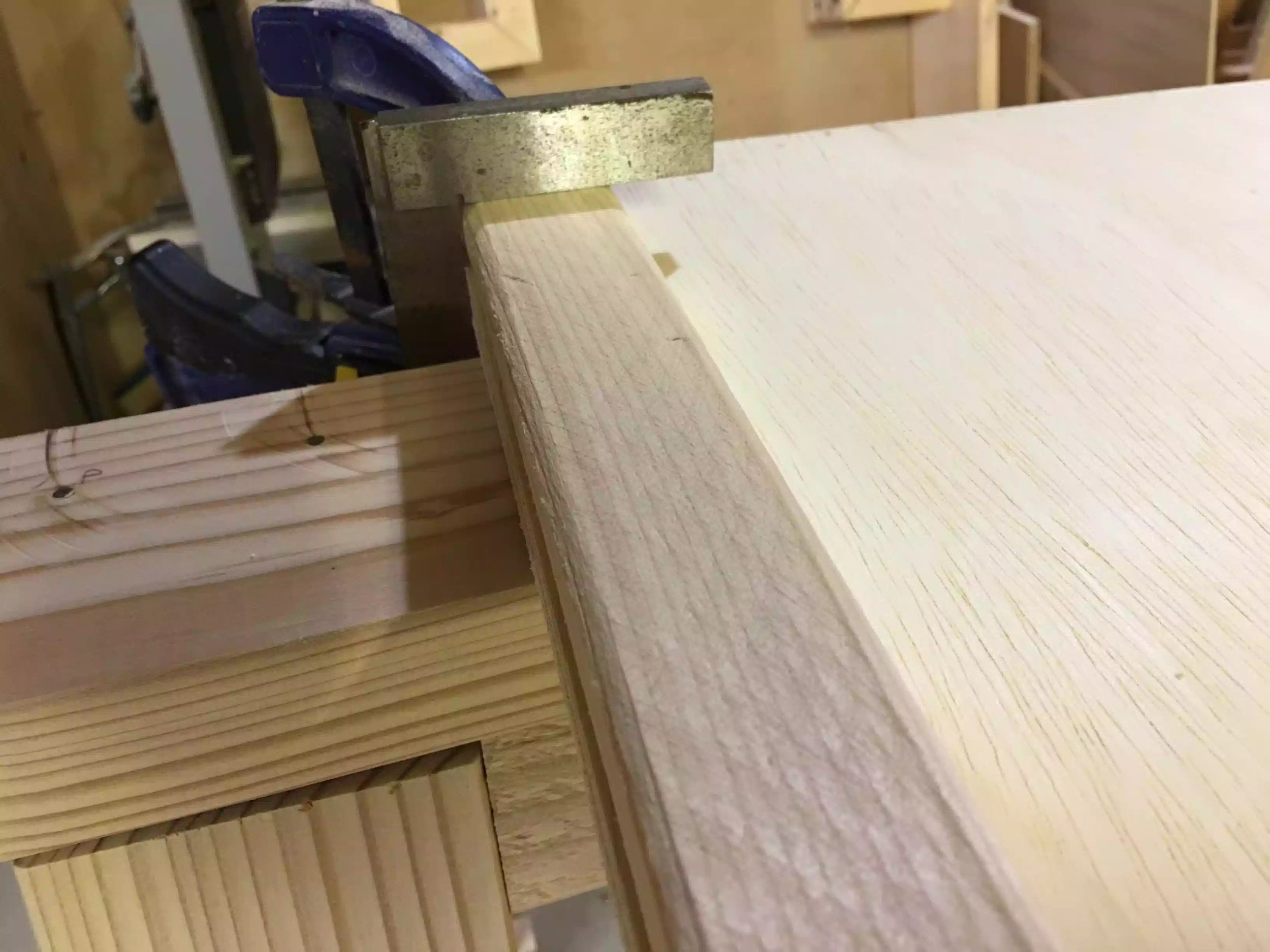 I used my machinist square to make sure the face frame is flush to the plywood edge, because that is where my legs will be secured to the divider, everything looks square and flush. I am looking for no daylight between the square and the boards edge.