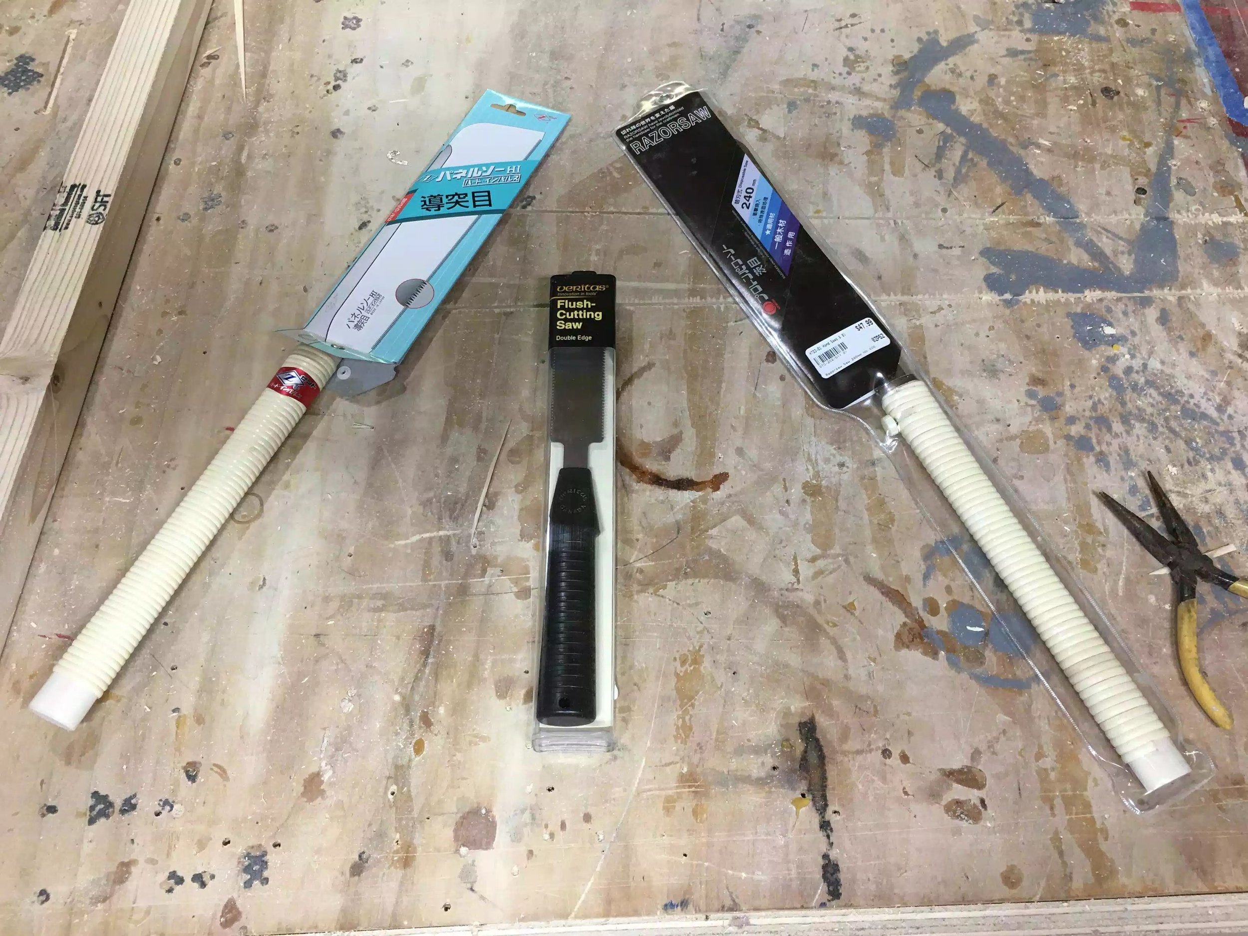 The saw on the left and right are Japanese handsaws one of them has a blade stiffner and one without,These saws are on the espensive side but they cut like a hot knife through butter.