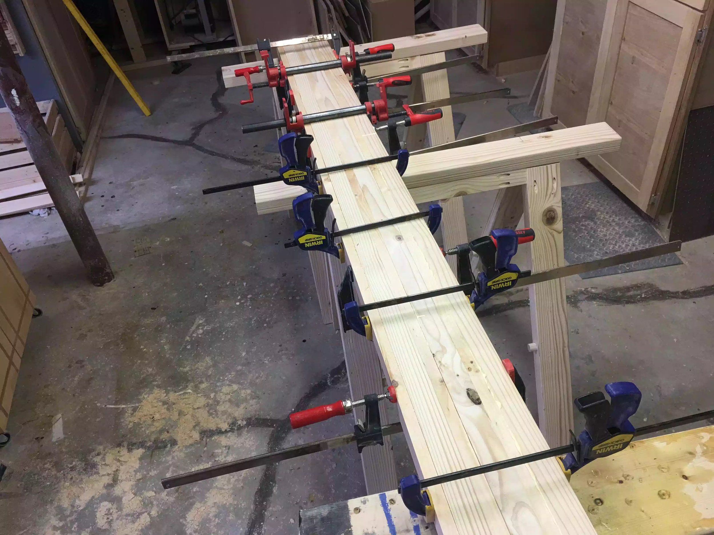 Here are the boards all clamped together for the night, instead of clamping each individual leg I organized all the legs into one assembly . I just made sure that I orientated the board faces so as that the boards wouldnt be all glued together. I used a lot of clamps lol... its true what they say you can never have enough clapmps