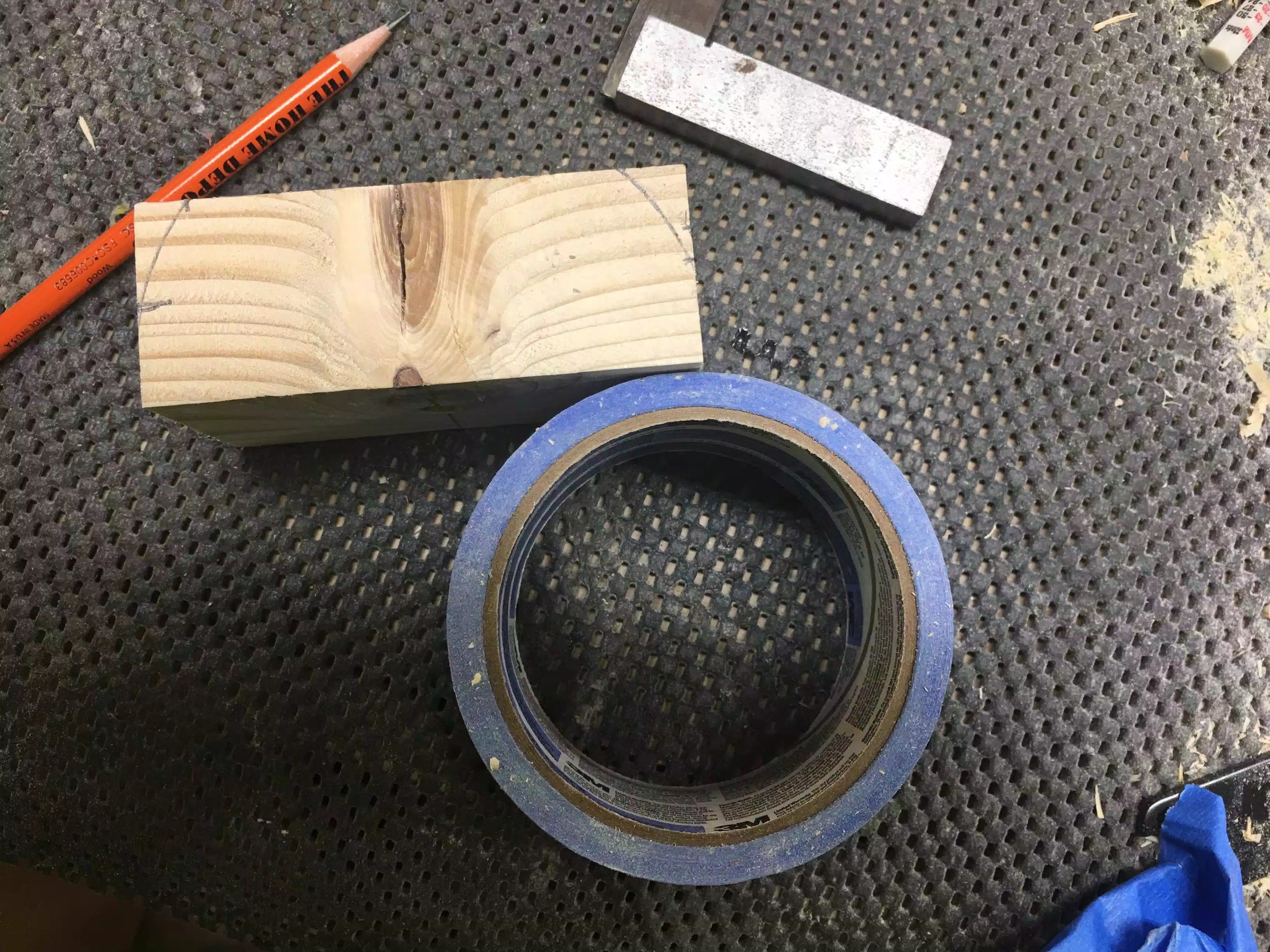 Finally I needed to add a round-over to mimic the other feet on the left and right side so I just used the masking tape to add a curve and then I cut it at the band saw, and smoothed it at my spindle sander