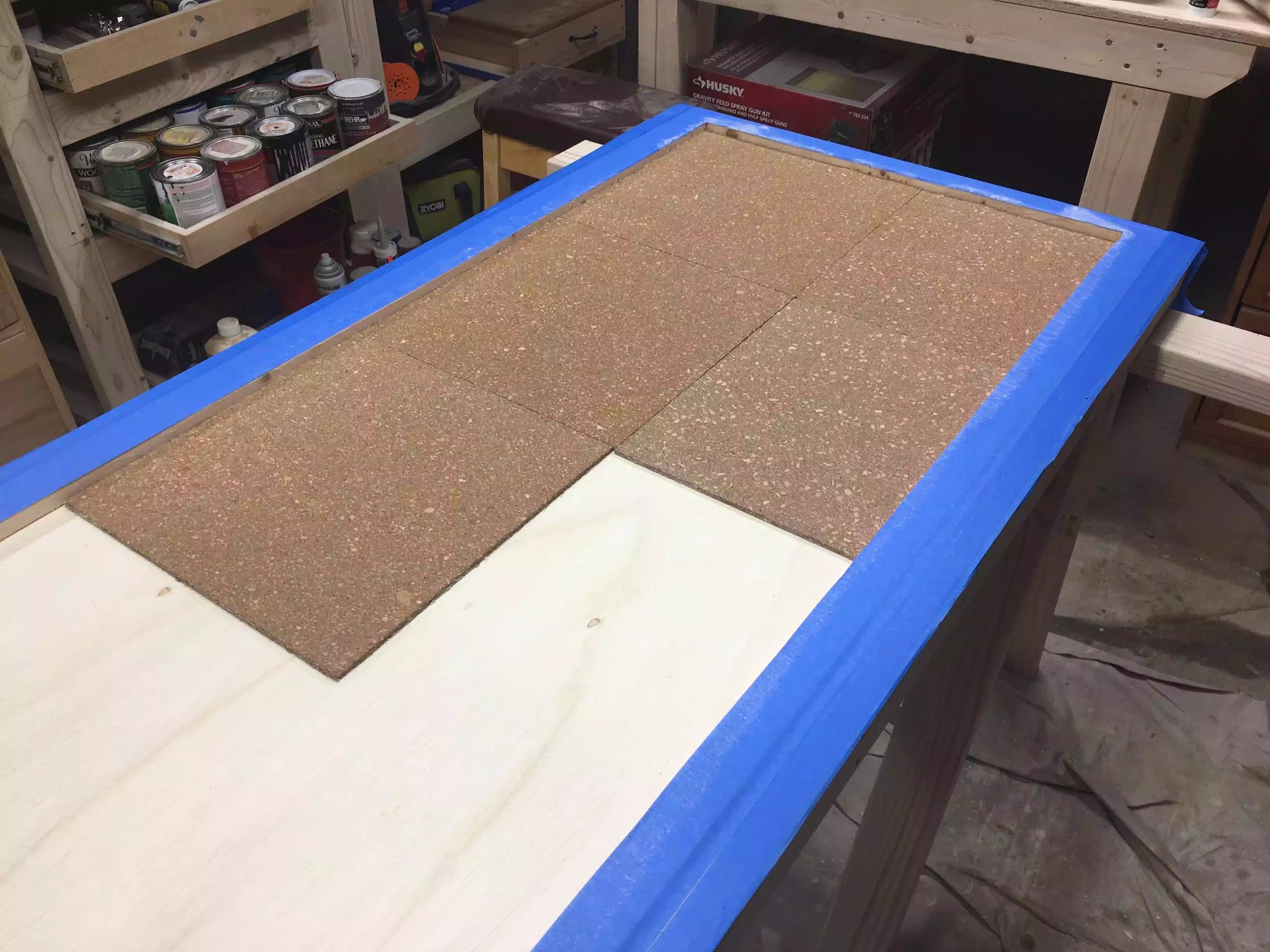 Here are the first few tiles laid so far so good, I am glad that I applied the painters tape to the outside because the spray adhesiview went everywhere.
