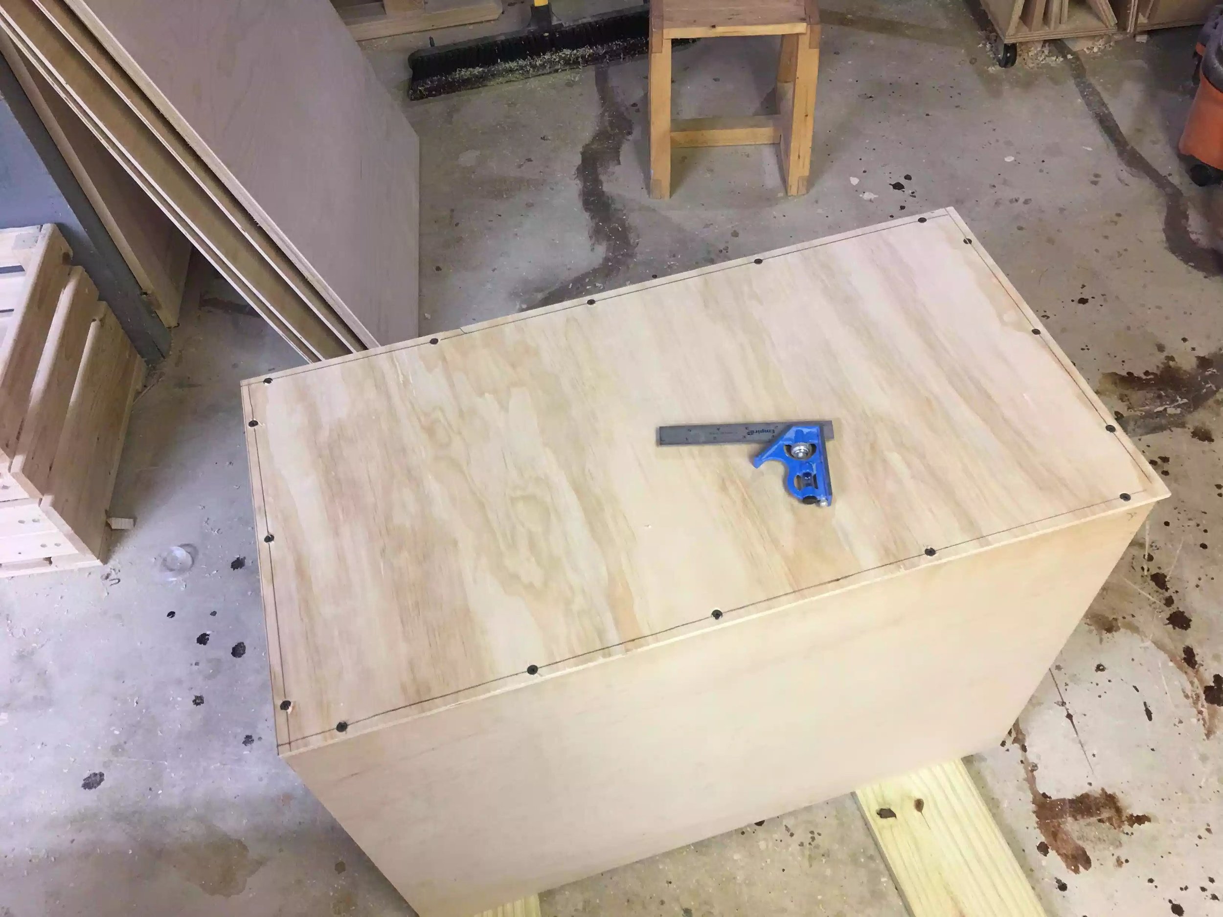 Here you can see the over-sized panel screwed and glued to the back of the carcass, I came back with my palm router and using a flush trim bit I finished flushing the back panel to give the back panel that finished look, even if the cabinet is not exactly sqaure.