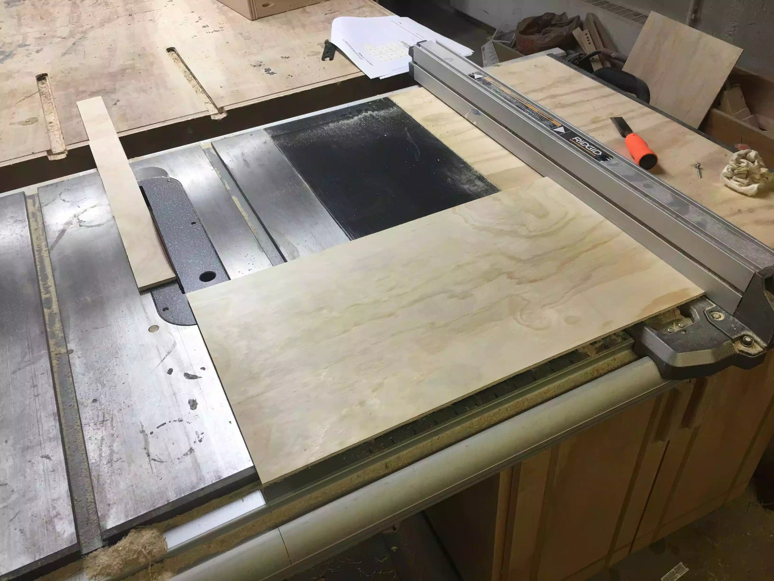 Here is a picture of me cutting the plywood into smaller sections to fit the drawer base.