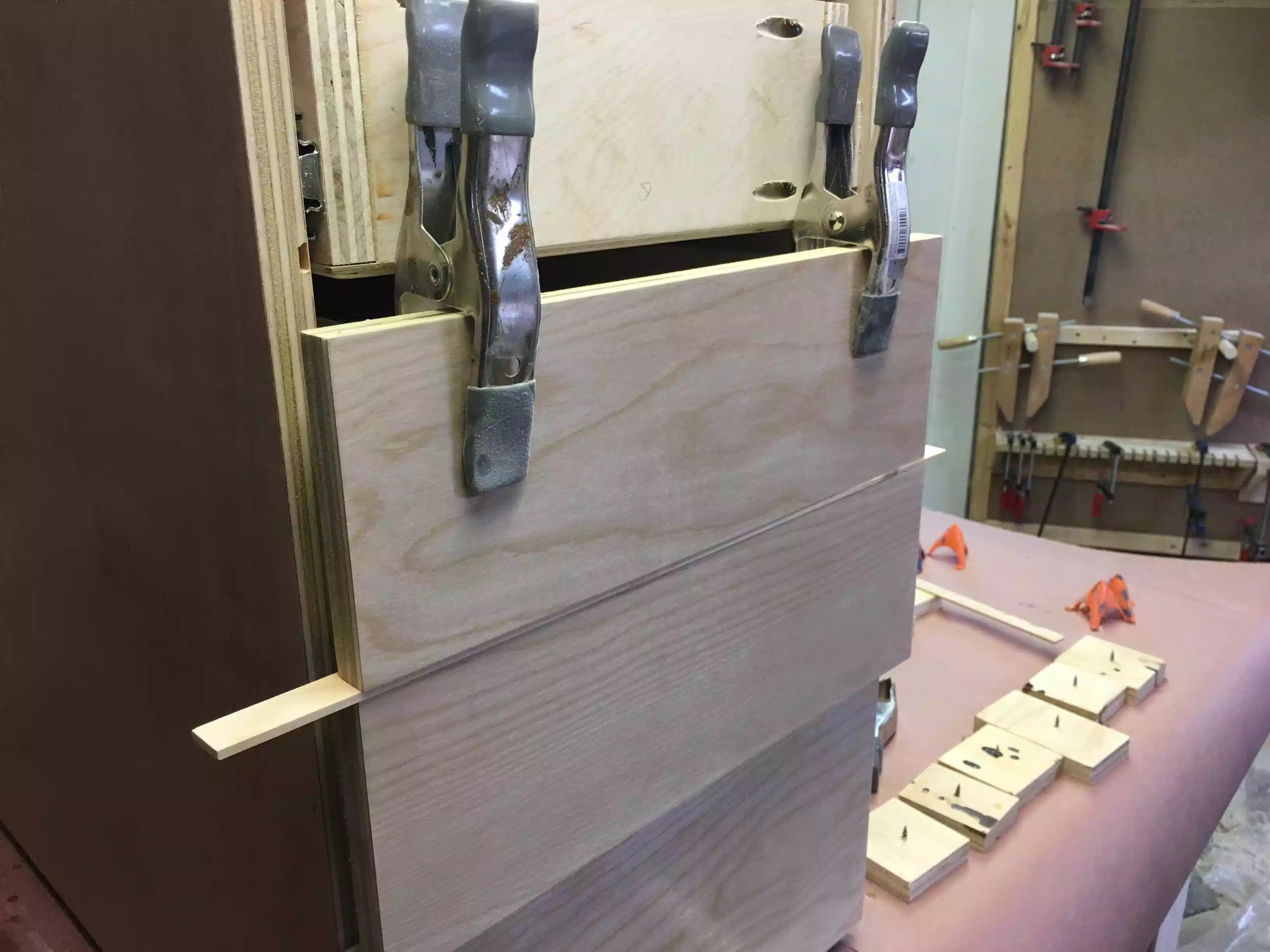 Here you can the spring clamps holding the false front in place, you can also see the 1/8" thick spacer under the false front.
