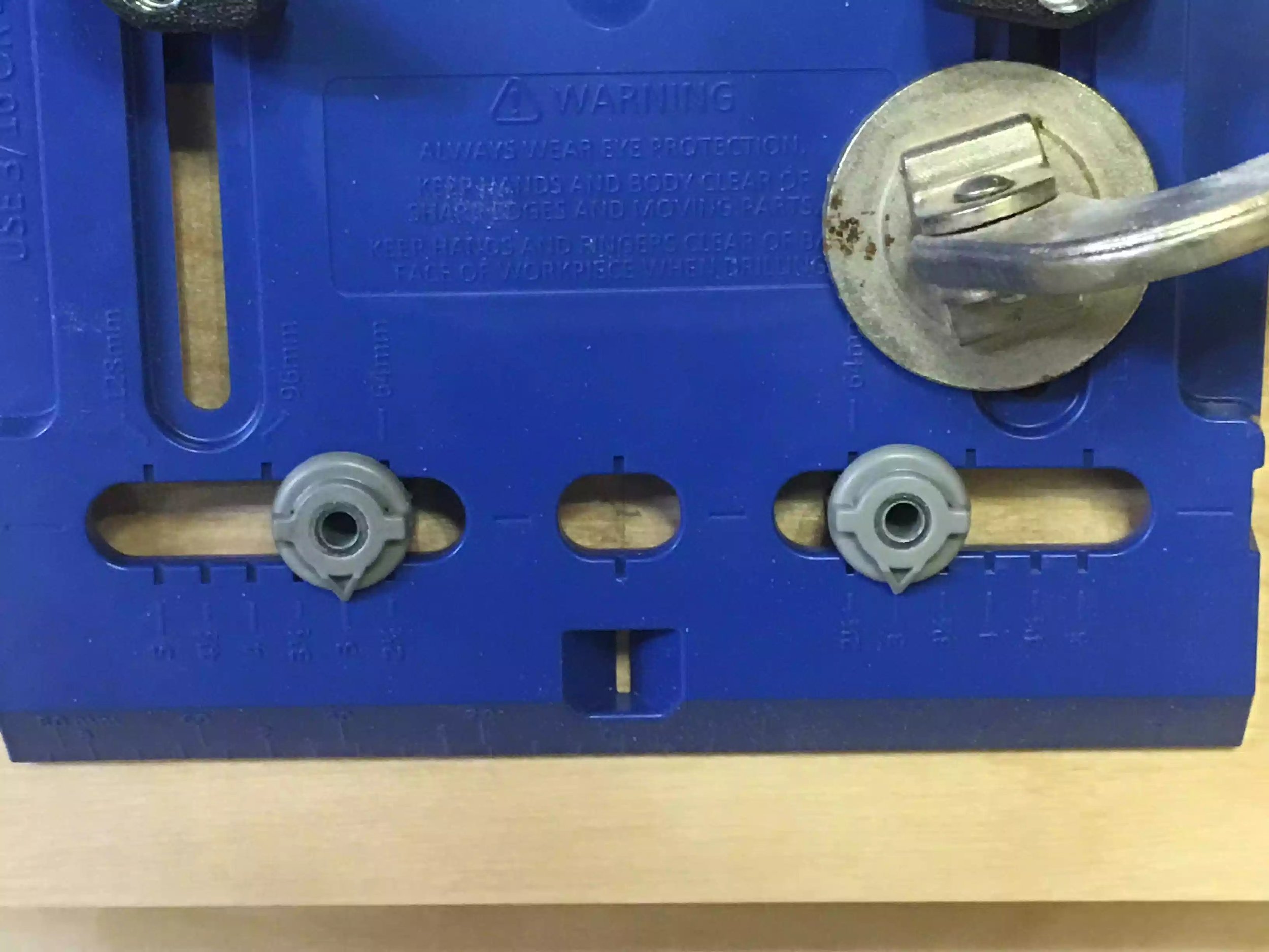 The grey round knobs are the drill guides that you can adjust depending on the size of the pulls you are using, since mine were shop made I don't think they were a standard size.