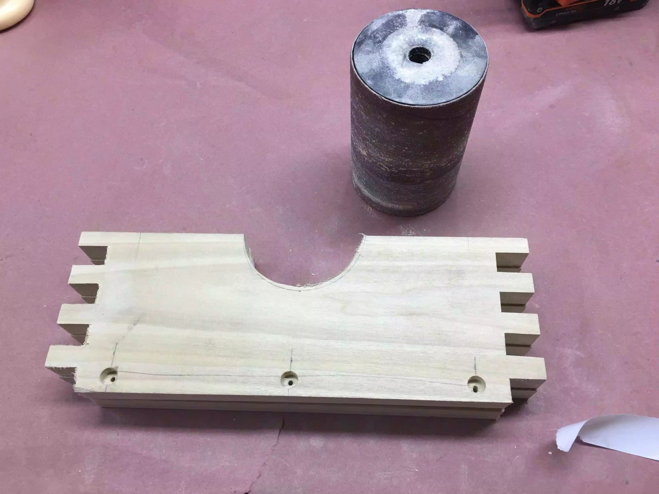 Here you can see the spindle sander sleeve that I used to create the arc. I used double sided tape to stick both sides together for the cutting and sanding parts of this step.