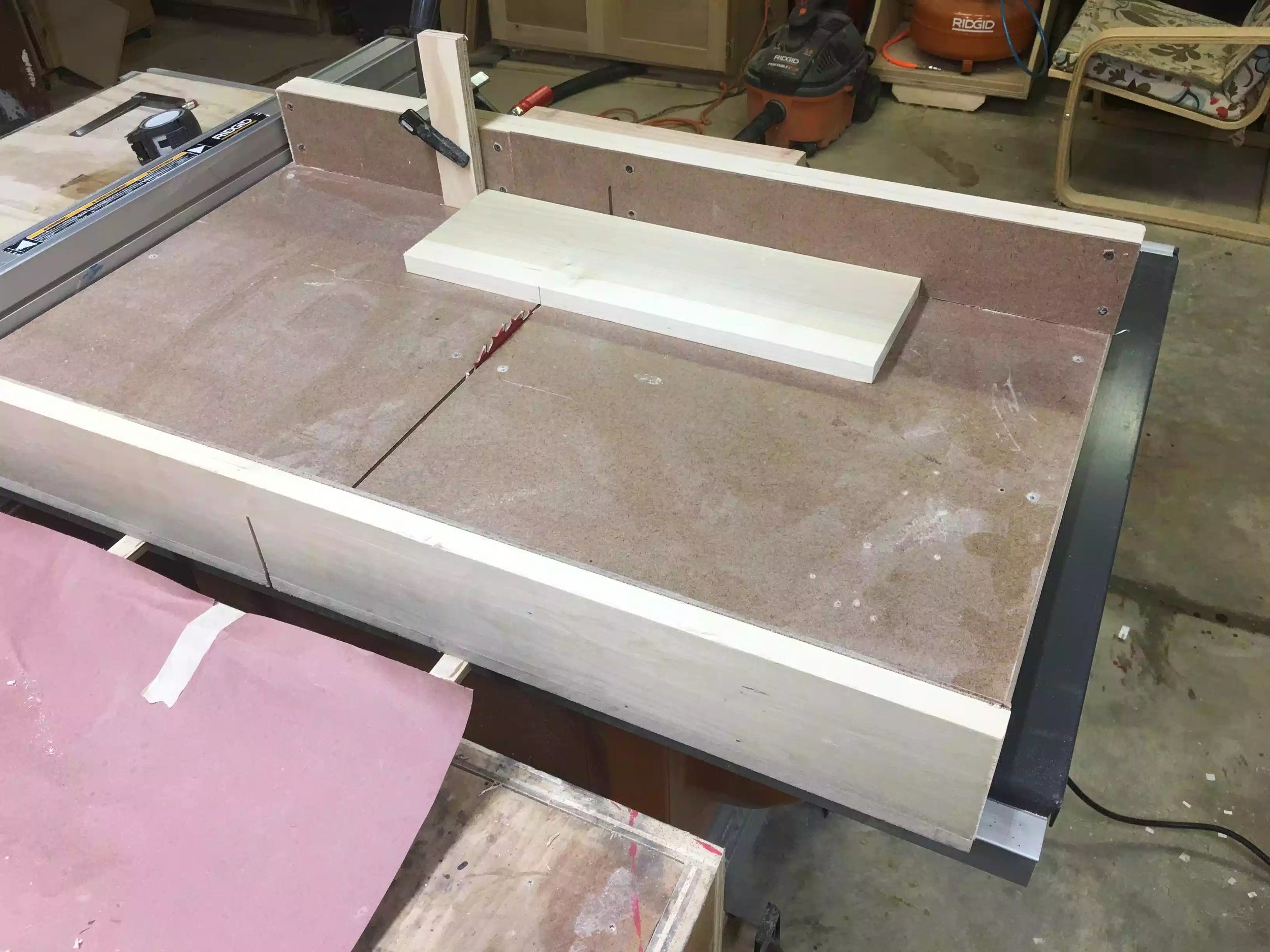 Here is my cross-cutting sled is not fancy but it’s dead on accurate. You can also see the stop-block which is nothing more than a scrap of plywood clamped with the sled fence.