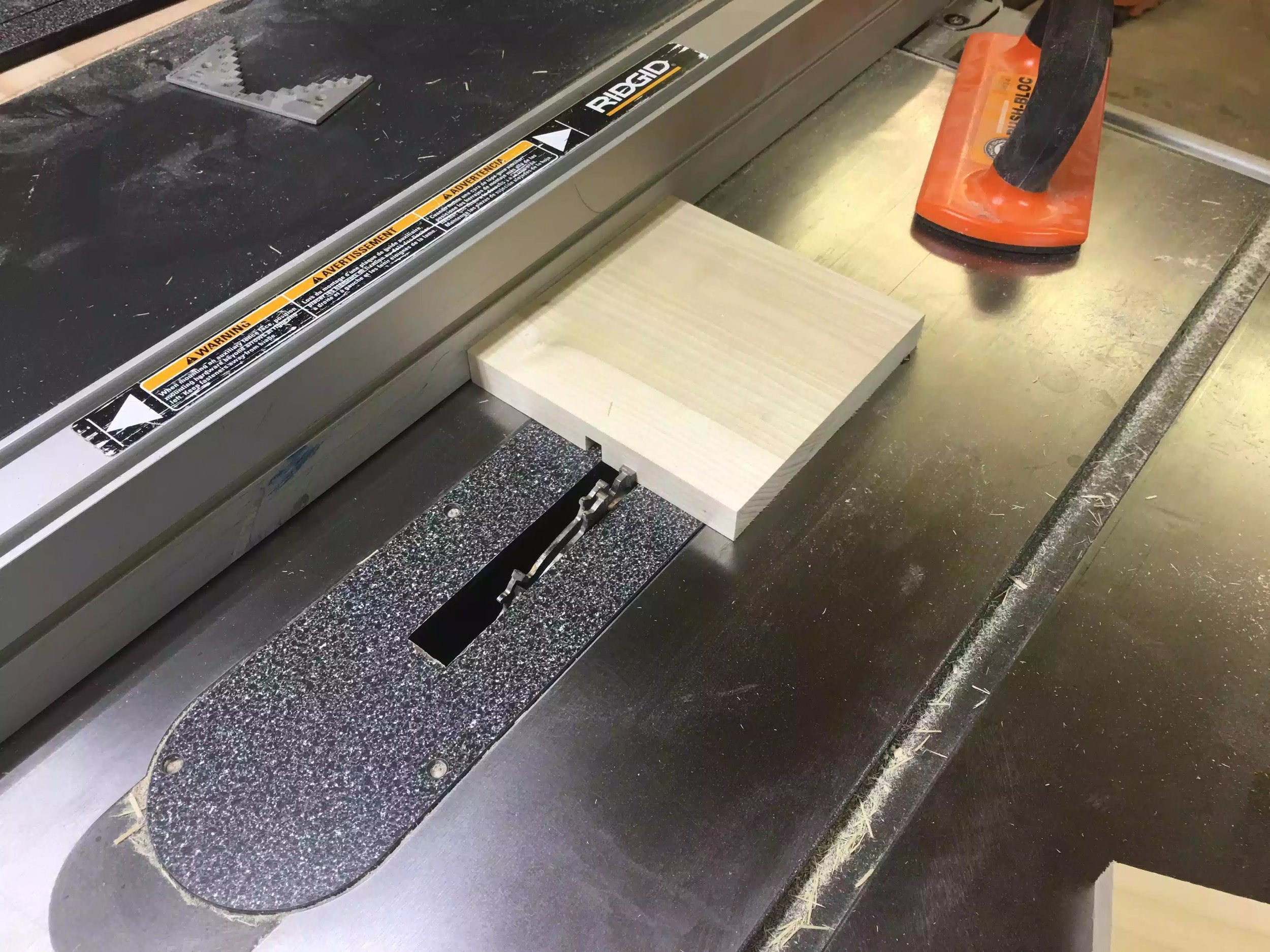 Here you can see the work-piece butted up to the fence and ran through the blade, once this is done I rotate the piece 90° to get the other groove.