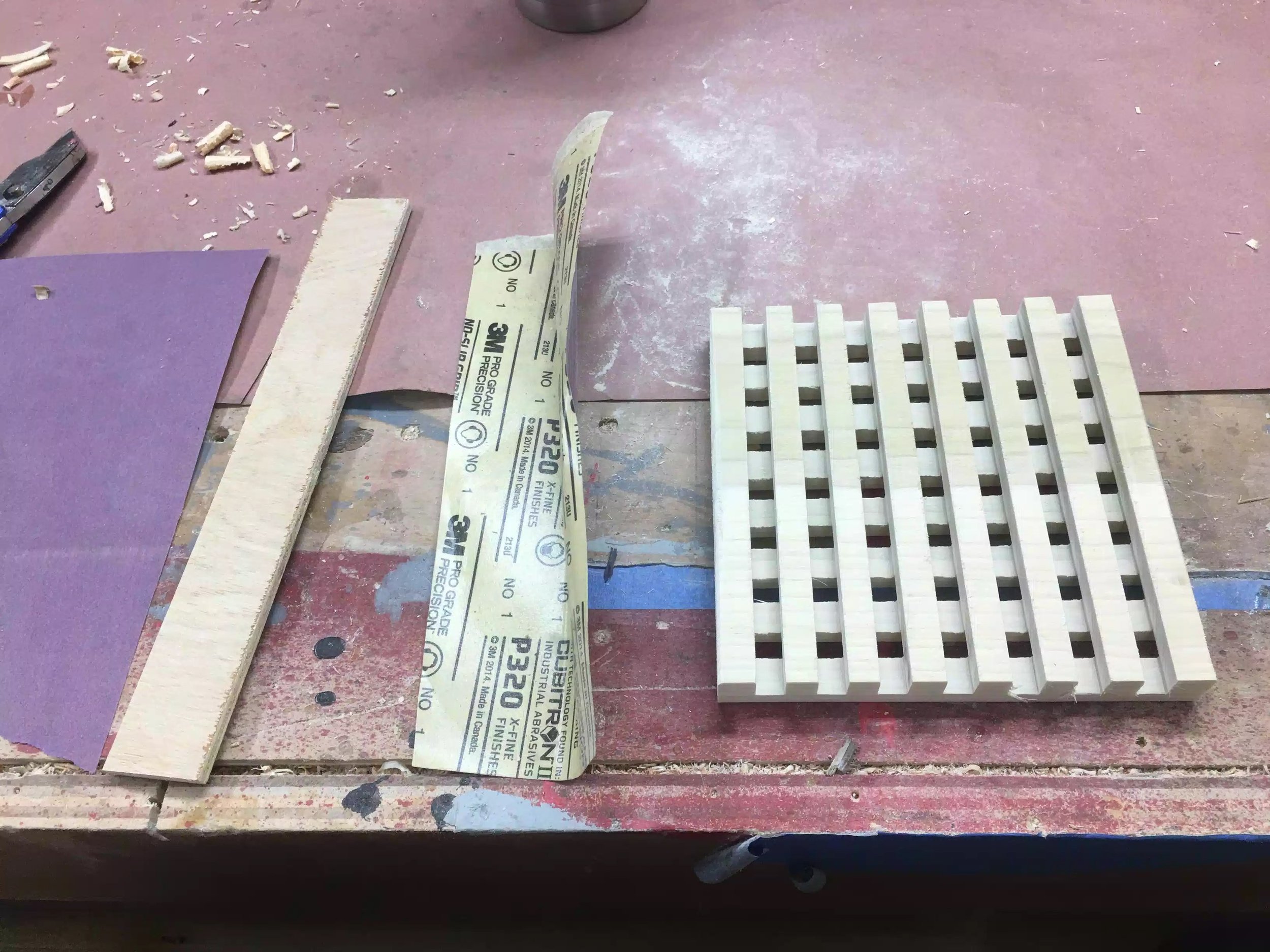Here is my solution to sanding in between the grooves. Some various grits of sand paper finishing with 320 grit and a piece of 1/4” plywood scrap. I wrapped the paper around the plywood and went to town.