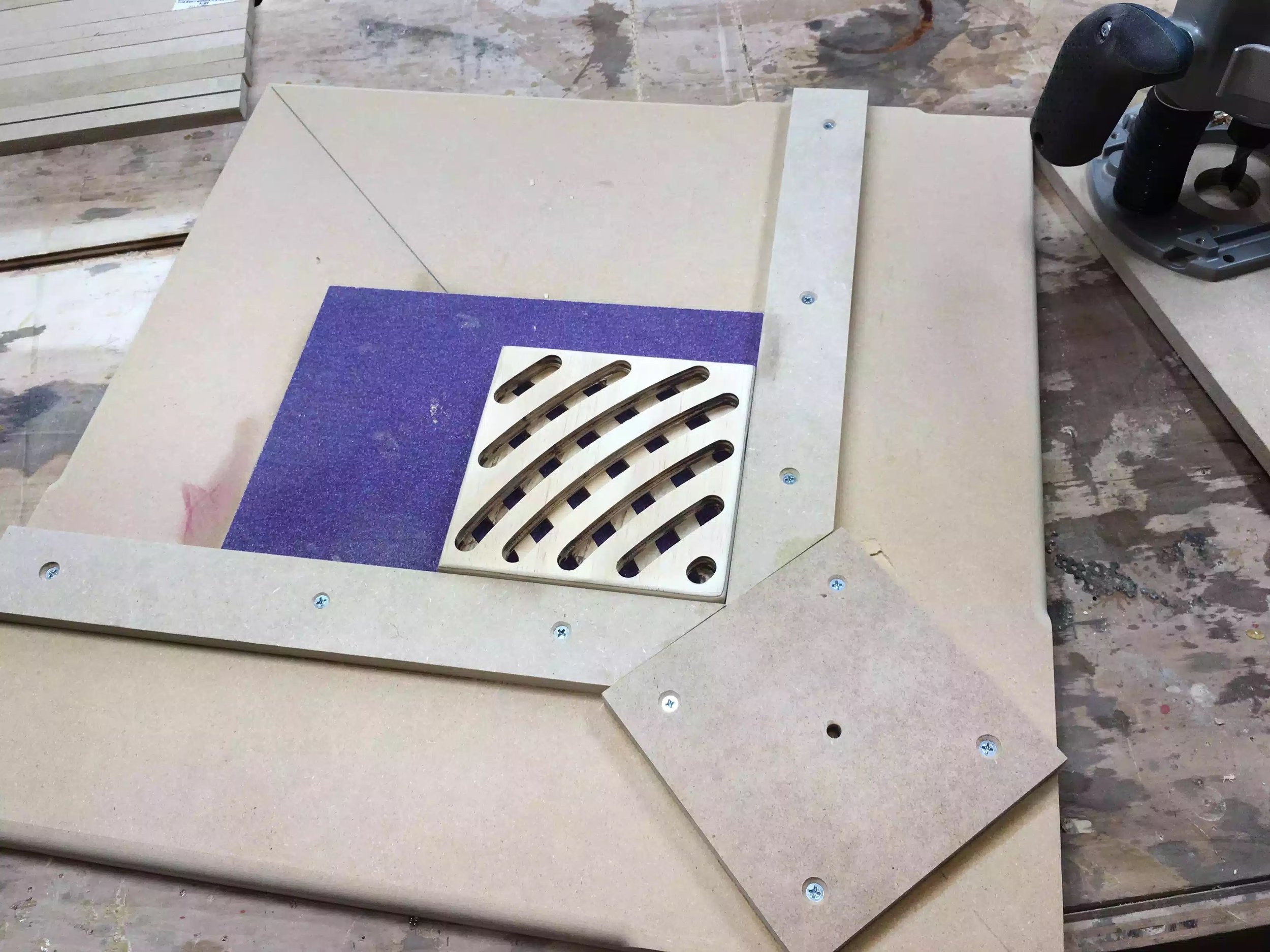 Here is a picture of the jig with the trivet blank positioned between the fences, I also used self adhesive sand paper to help keep the blank positioned while using the router.