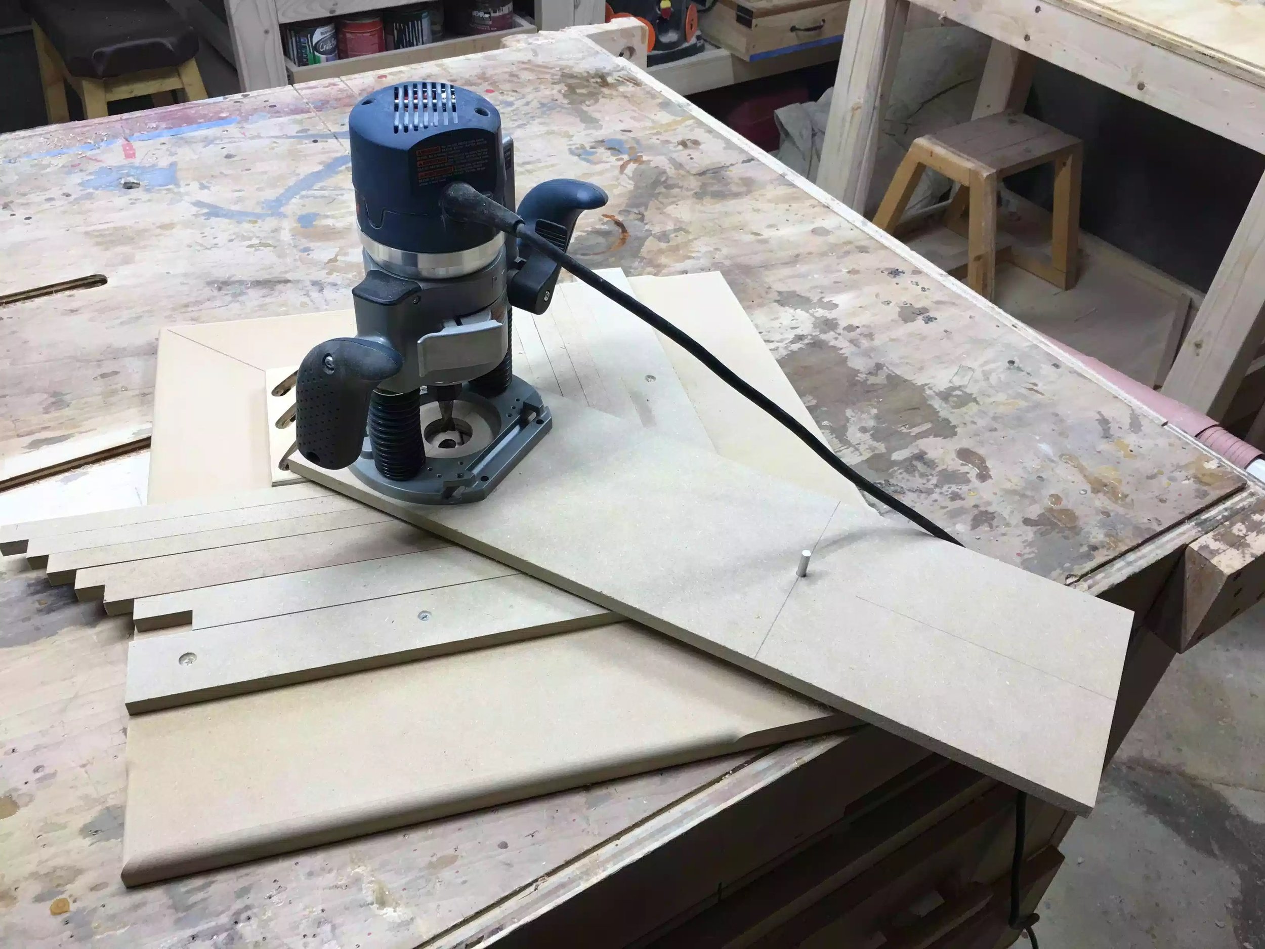 Here is the jig in use, you can see the router attached to the pivoting arm which is how I achieve the curved grooves in the trivet.