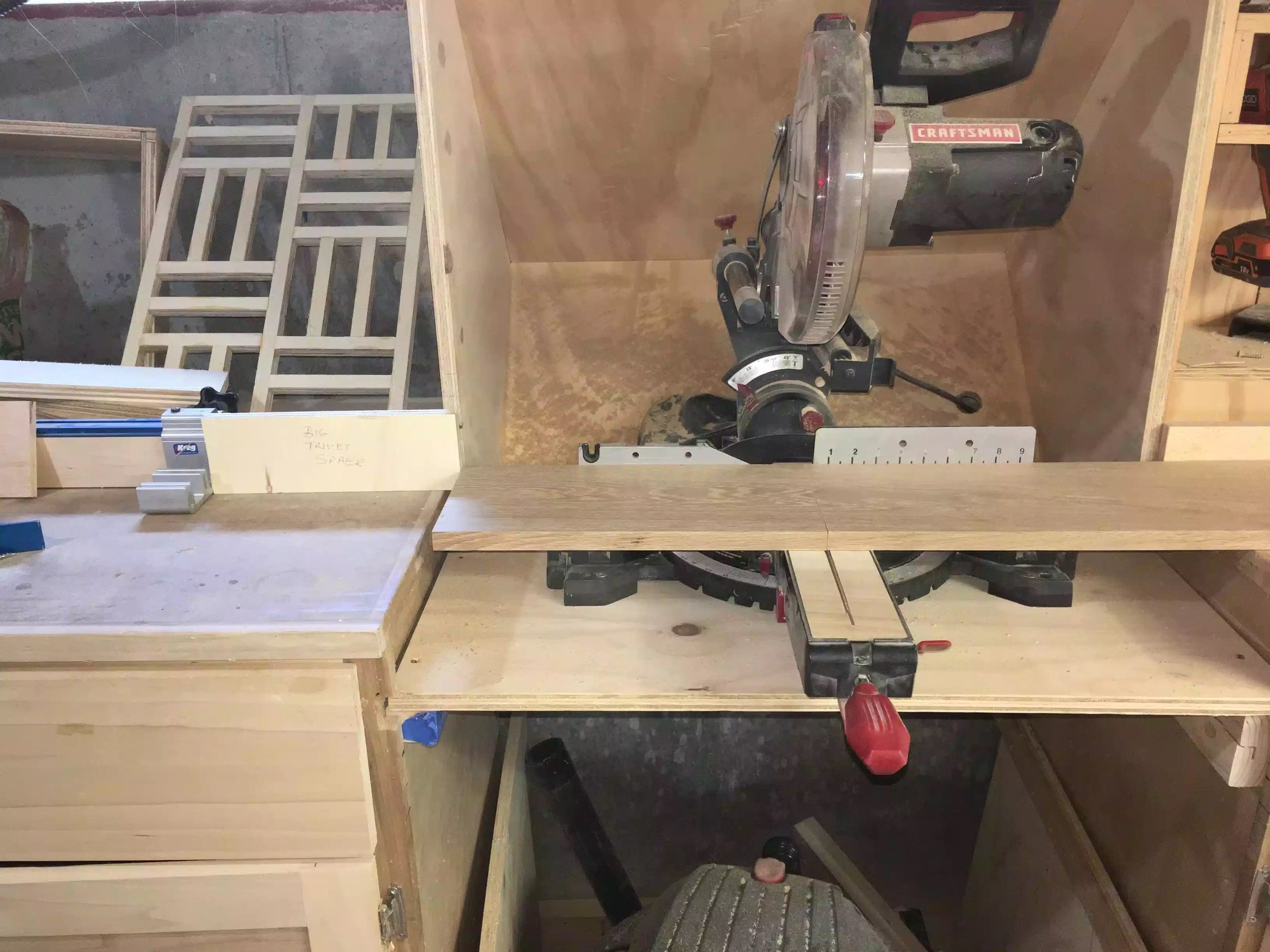 Here you can see the oak sitting on the miter saw deck and the spacer block is establishing the positive that I need to make all cuts the same size.