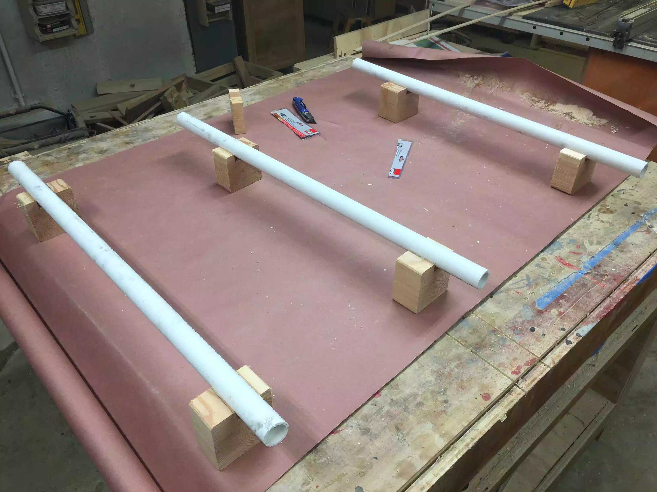Here are the white PVC pipe that I have nesting in some scraps, but didn’t work great because the scraps kept falling over.