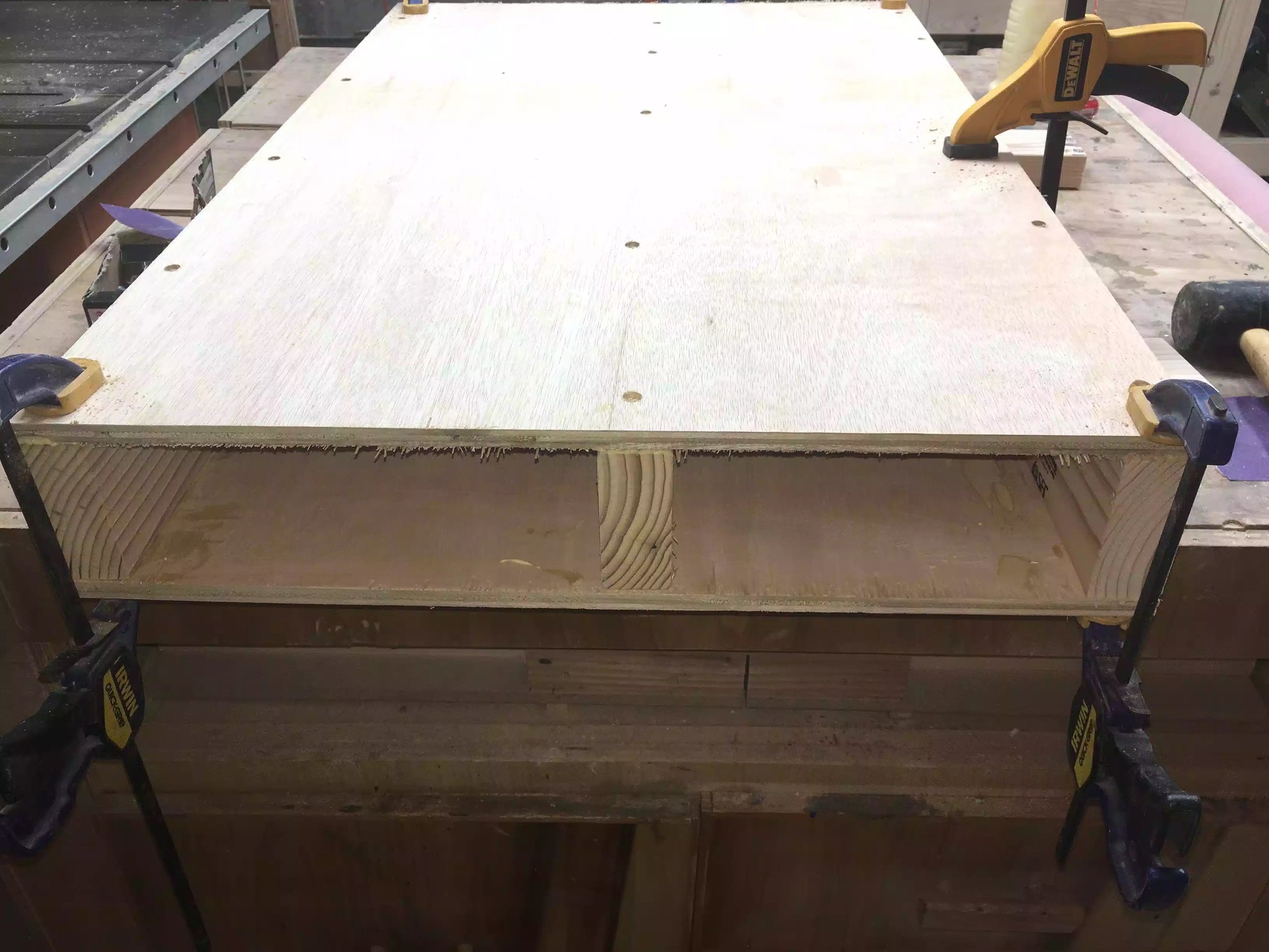 Here is the base with the plywood sheets on top and bottom with the lumber sandwiched in the middle, I clamped the plywood onto the lumber while screwing everything together, glue was also added. I counter-sunked the screws because I will be coming back and filling all these holes later on in the project.