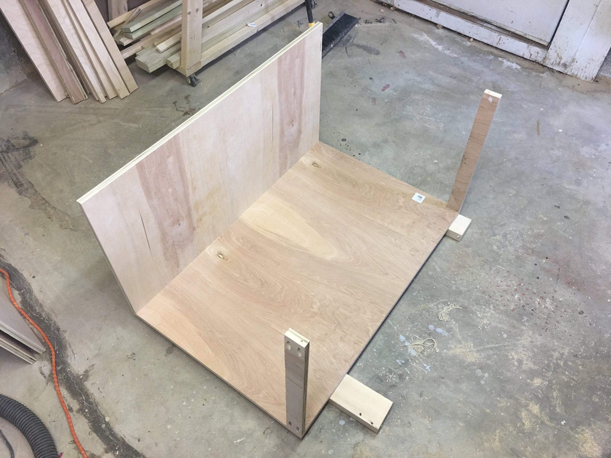 Here you can see the temporary support stretchers I screwed to the cabinet side. This way when I lie the base on the sides Dado it can rest on the supports as I secure the base with screws