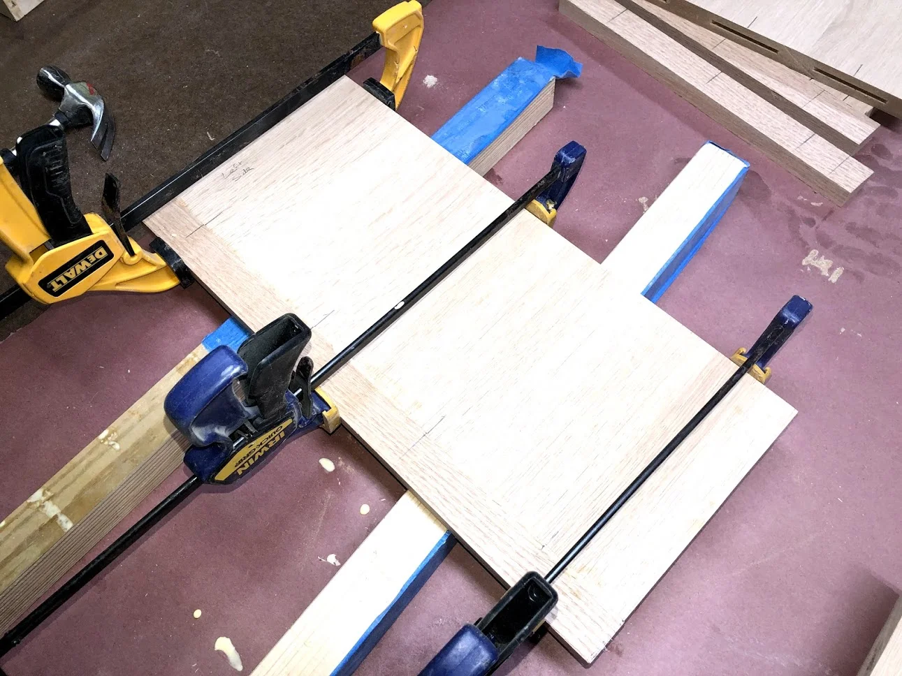 Here is the side receiving its solid oak edge banding and getting clamped up.