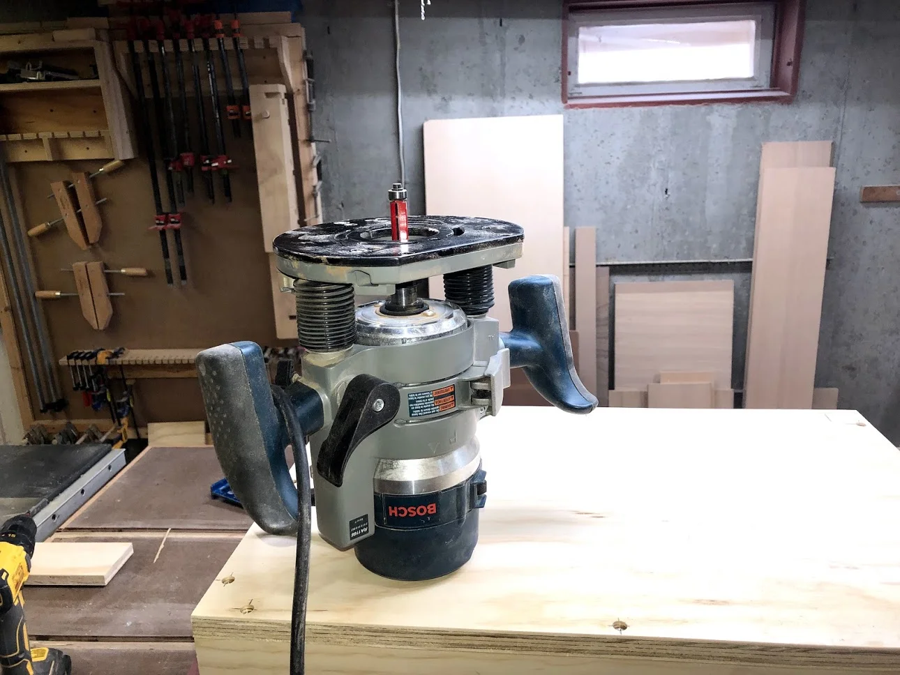 With the base secured it was time to use my router with a flush trim bit to cut the excess material away from the base.
