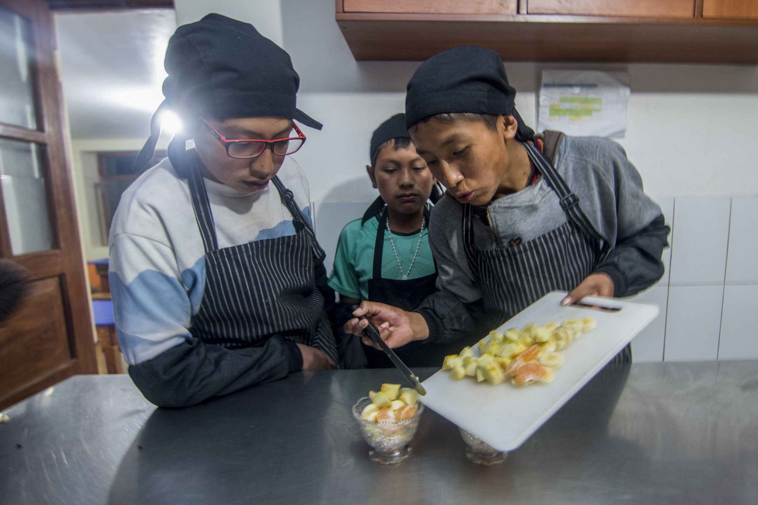 Children learn new cooking skills in the Boarding Houses kitchen.