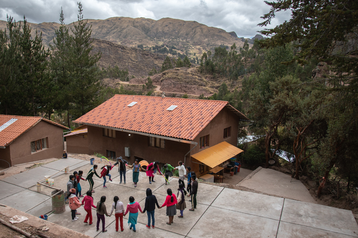 The young people form a circle for an early morning game.