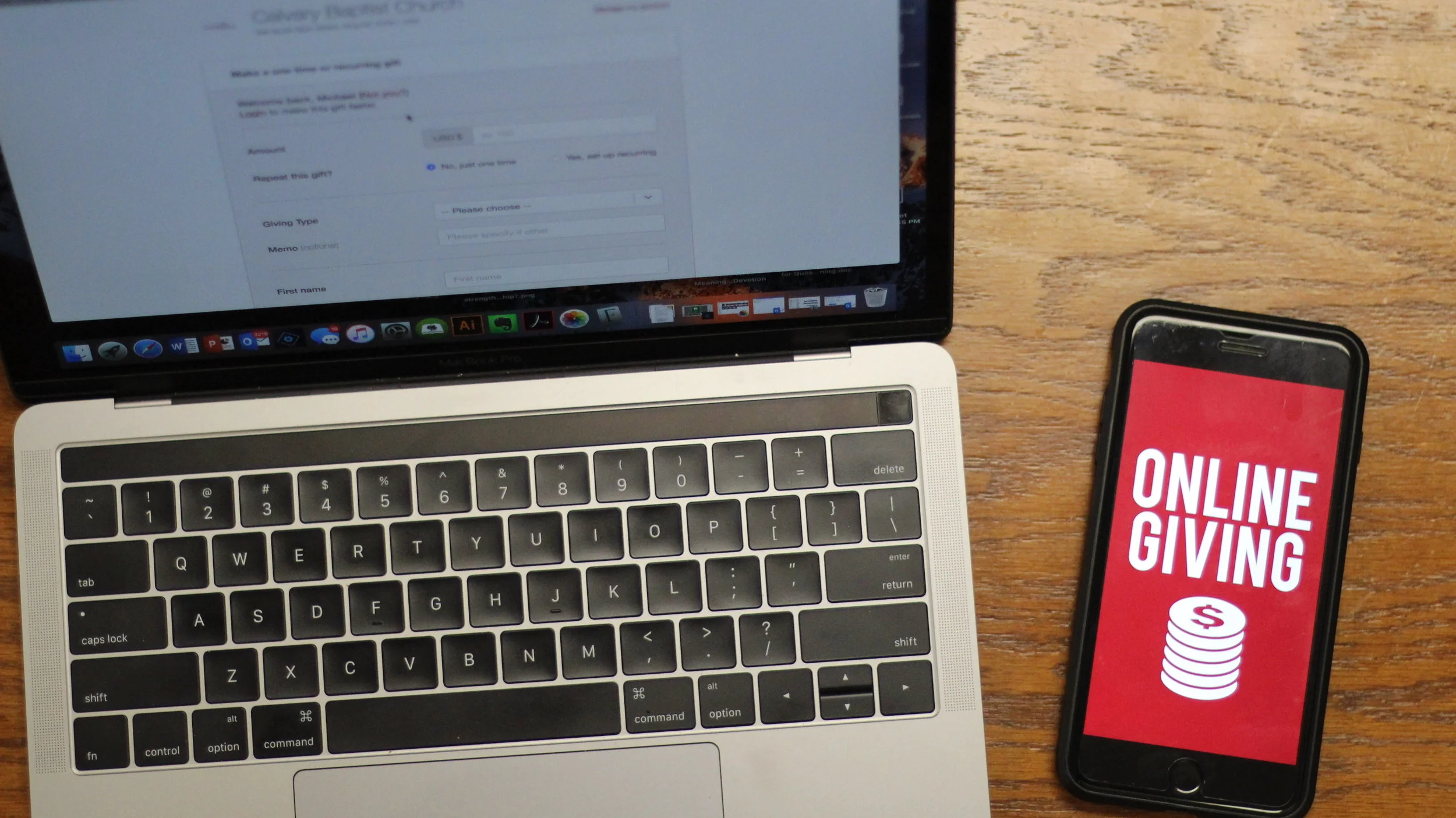 online giving app on a cellphone on a laptop computer.jpg