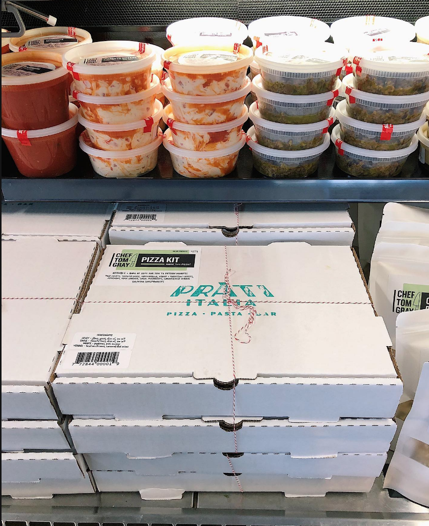 Grocery display case of pasta, sauces and pizzas from Chef Tom Gray