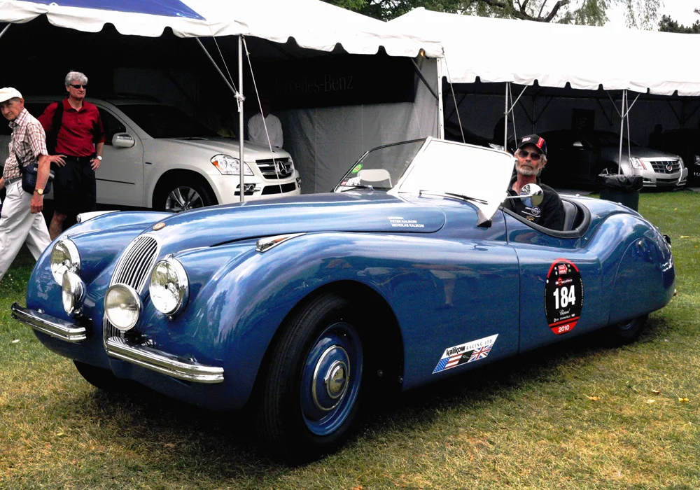 Charlie drives XK120 #670150 up to take the Mille Miglia award. Waiting to take the award for The Most Outstanding Jaguar presented by jaguar Cars of NA is Drake Darrin and with John Fitch aboard his C type. John drove this very car to a race win at Watkins Glen a number of years ago.