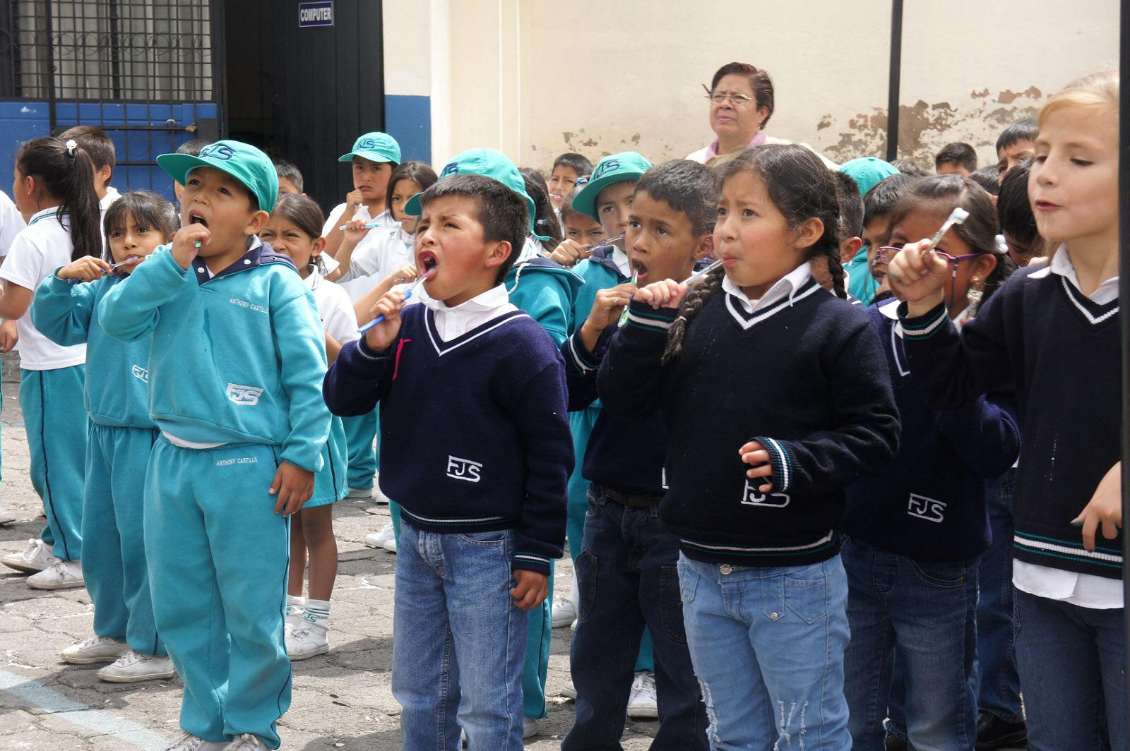 Ecuadorian students using their new toothbrushes