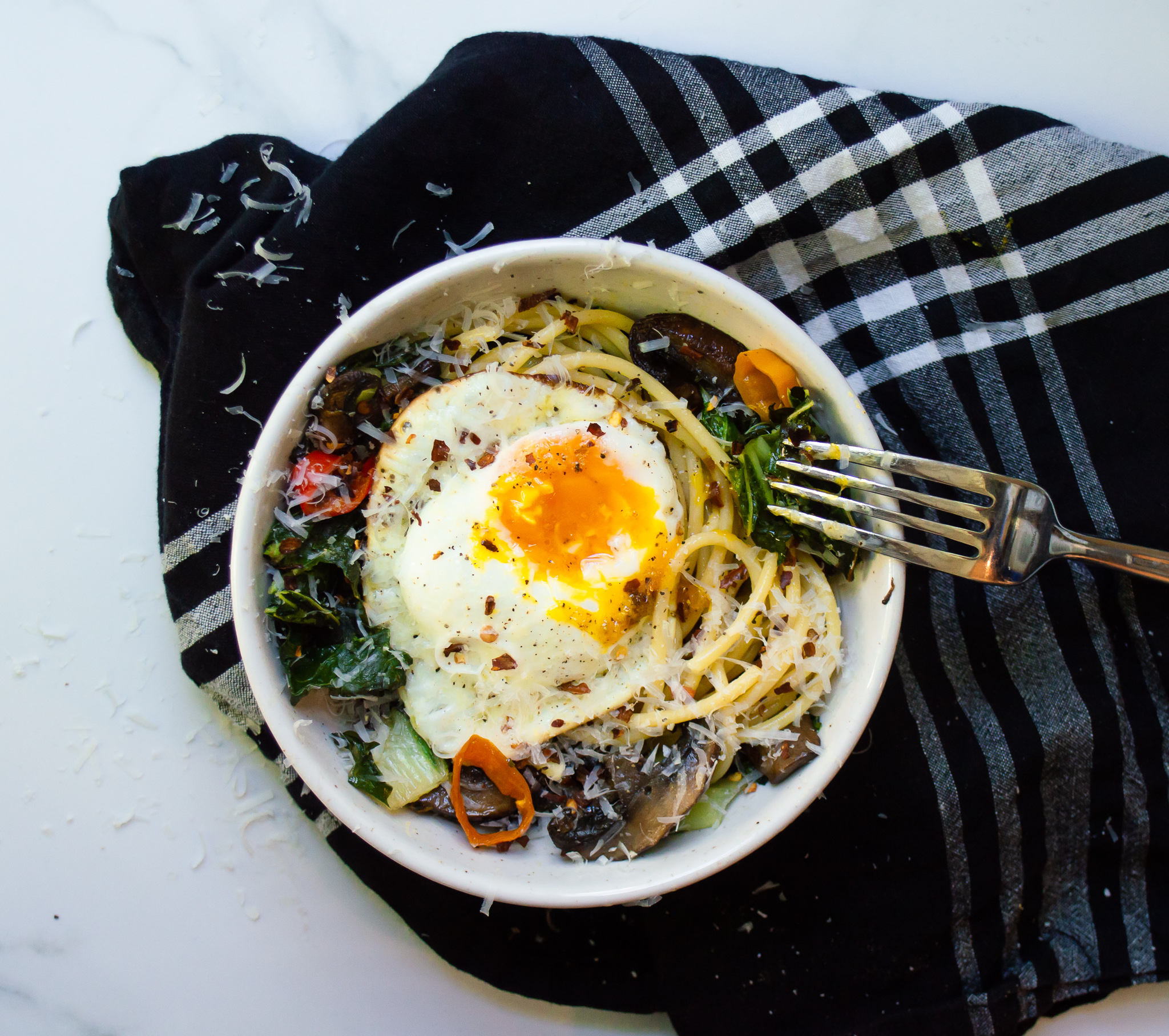My firm belief: pasta is always better if you #putaneggonit. Add some leftover roasted veggies, like mushrooms, peppers, and bok choy, and you've got my favorite breakfast. 