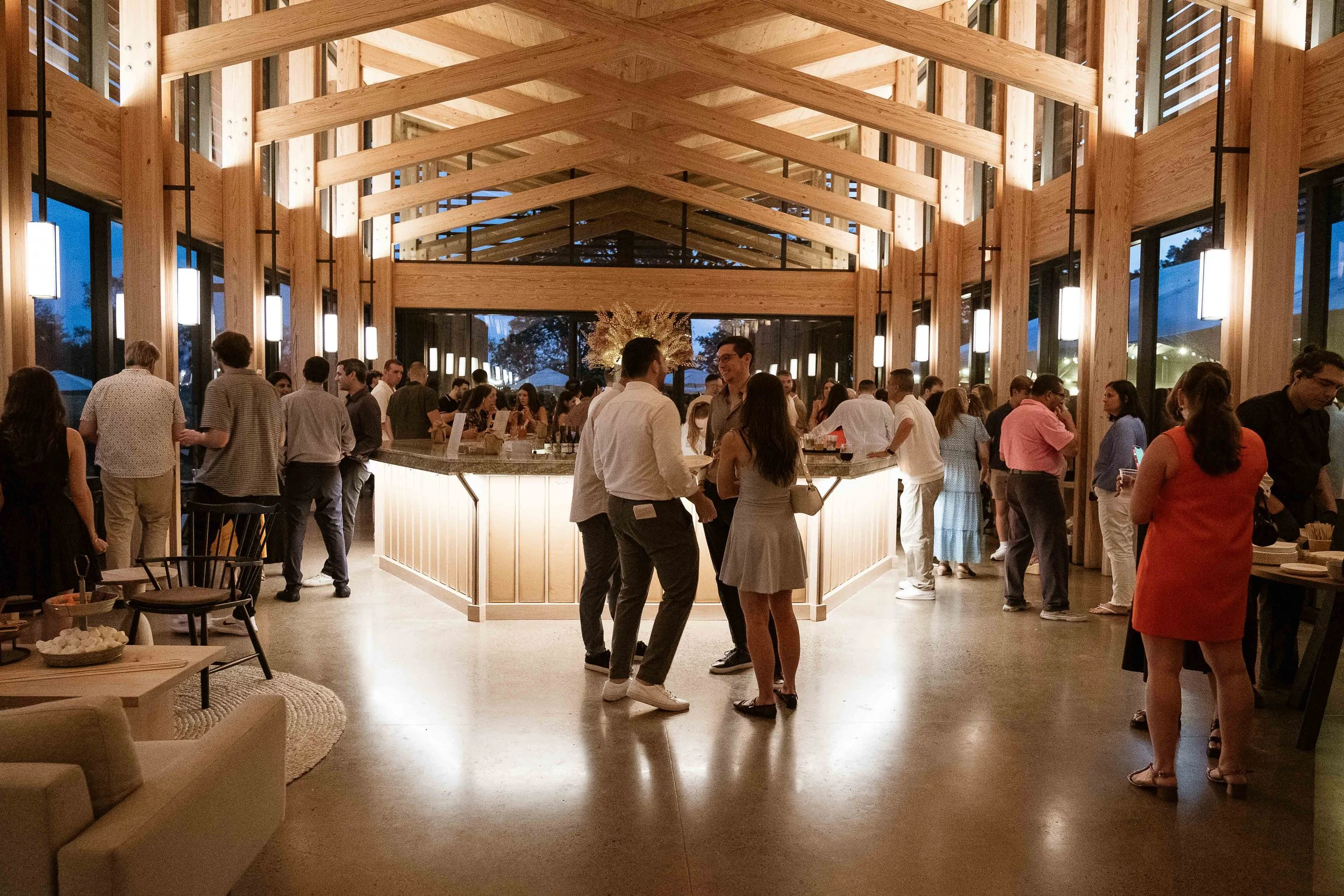 Modern farm brewery tasting room with laminated beam ceiling and hexagonal bar dimly lit evening private event photo by Cappy Hotchkiss