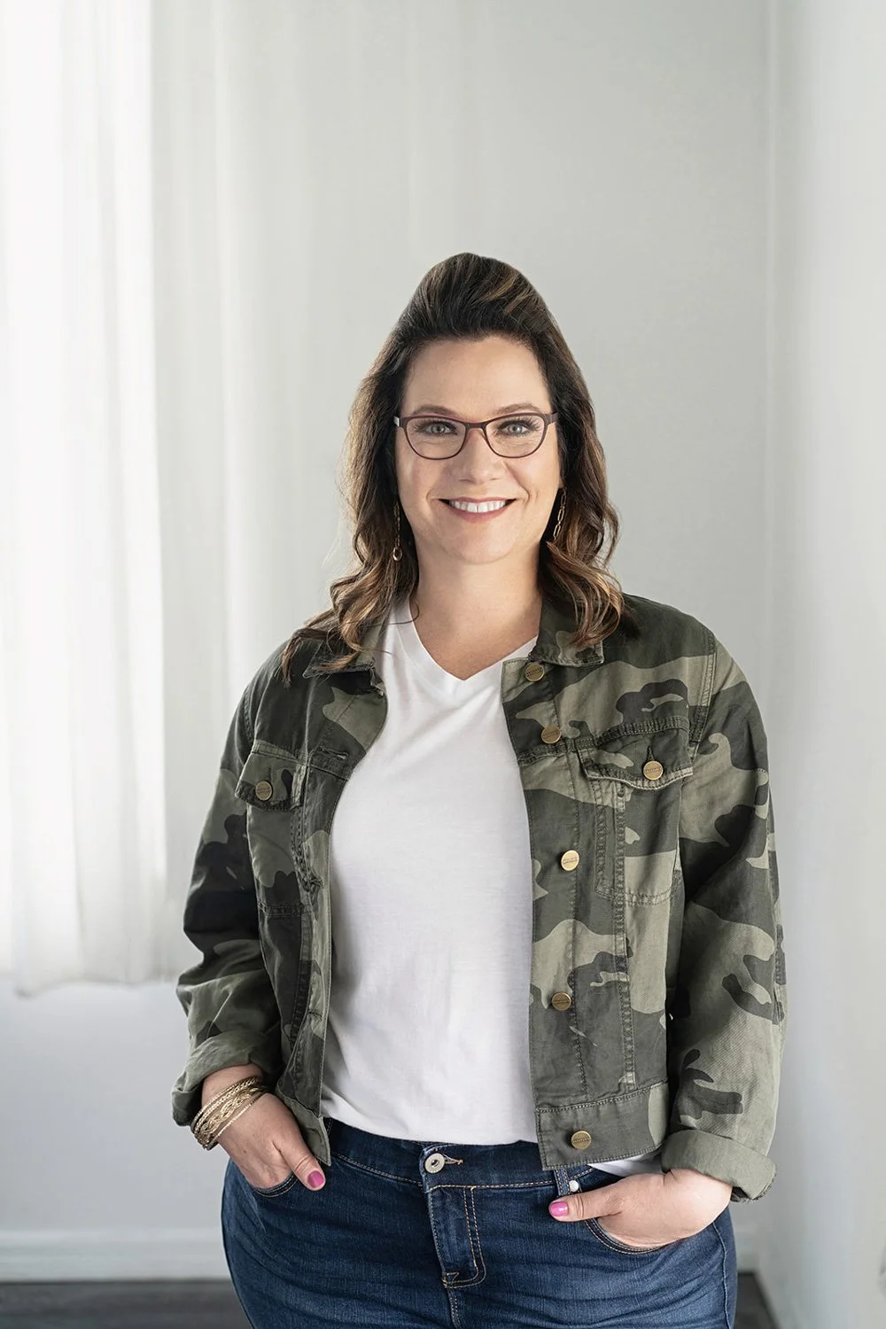Kim Kiel smiling in a camo jacket
