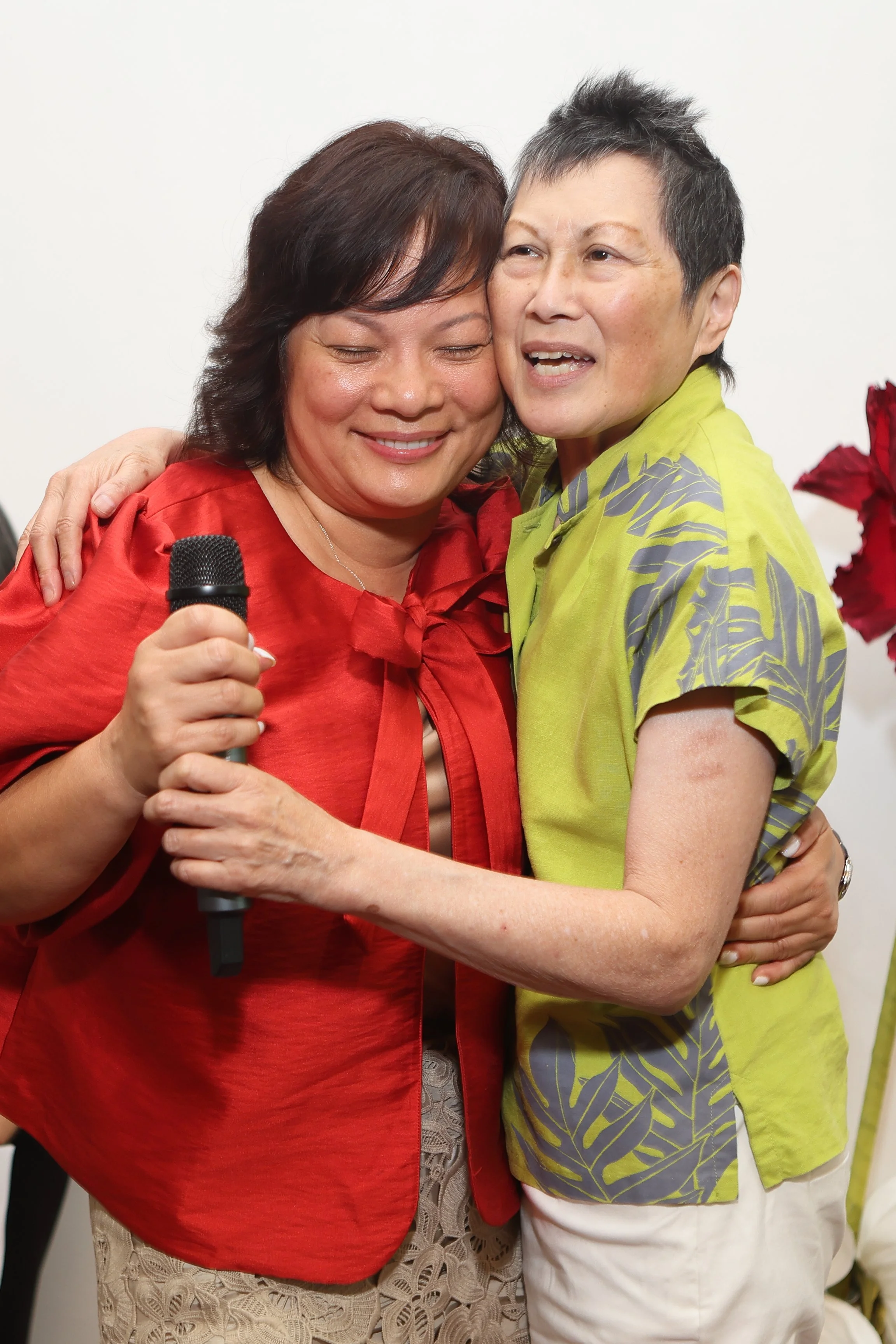 photo of May and Christine hugging at event