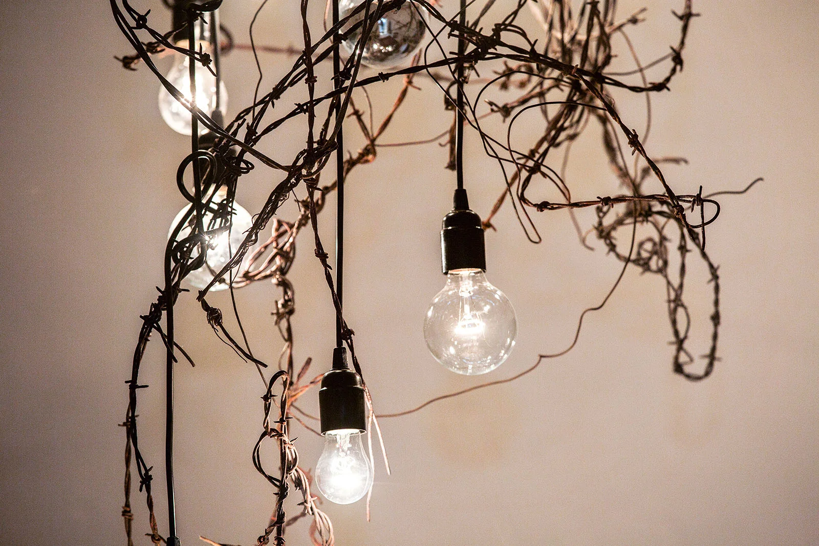 Chandelier we made from rusted barbed wire and wood
