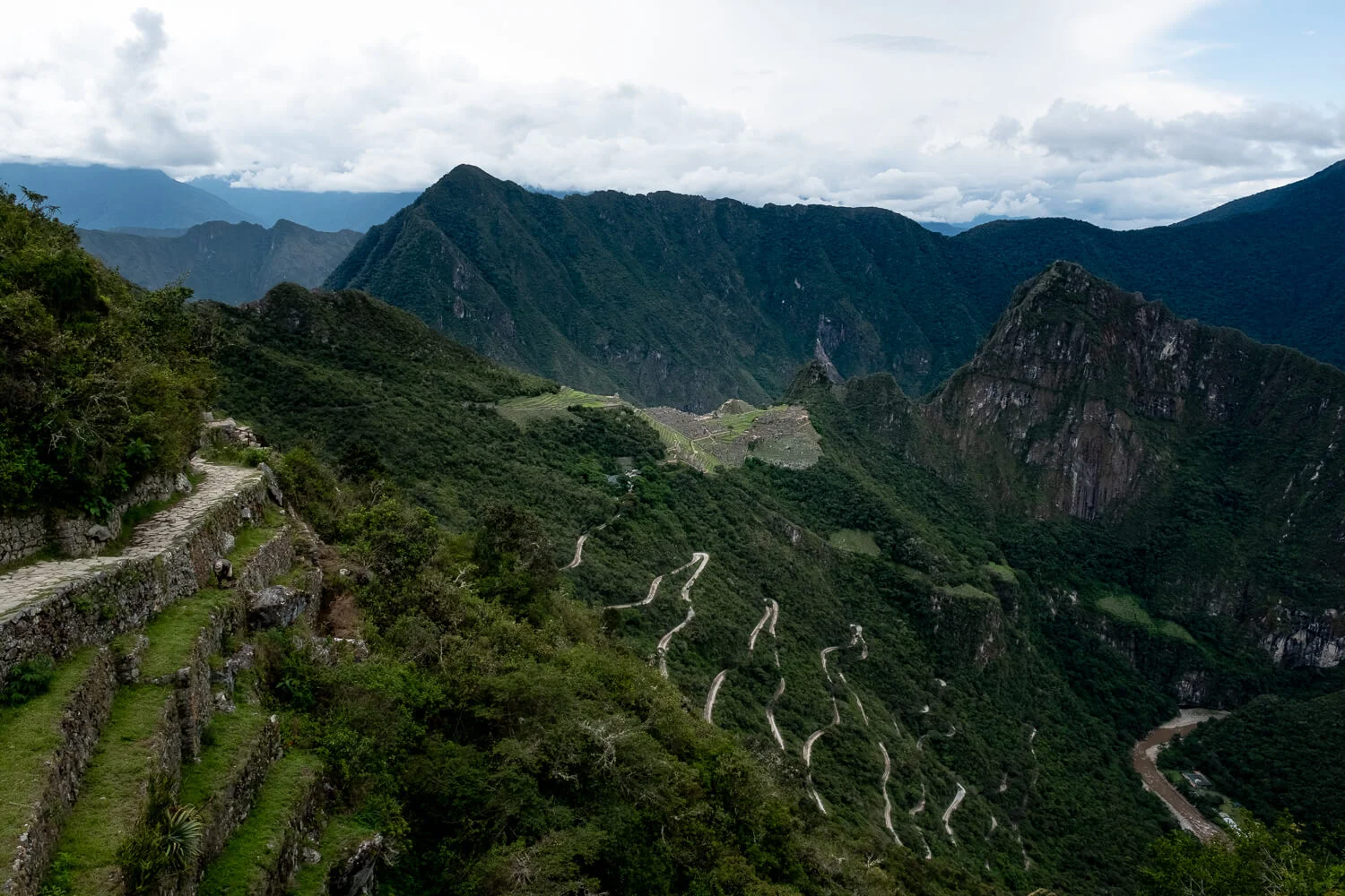 View of Machu Picchu from the Sun Gate. Travel photography and guide by © Natasha Lequepeys for "And Then I Met Yoko". #machupicchu #shortincatrail #2dayincatrail #incatrail #aguascalientes #sacredvalley #peru #travelguide #photoblog #travelblog #travelphotography #landscapephotography #travelitinerary #machupicchuitinerary #fujifilm #southamerica #visitperu #dayhike #ancientruins #hiking