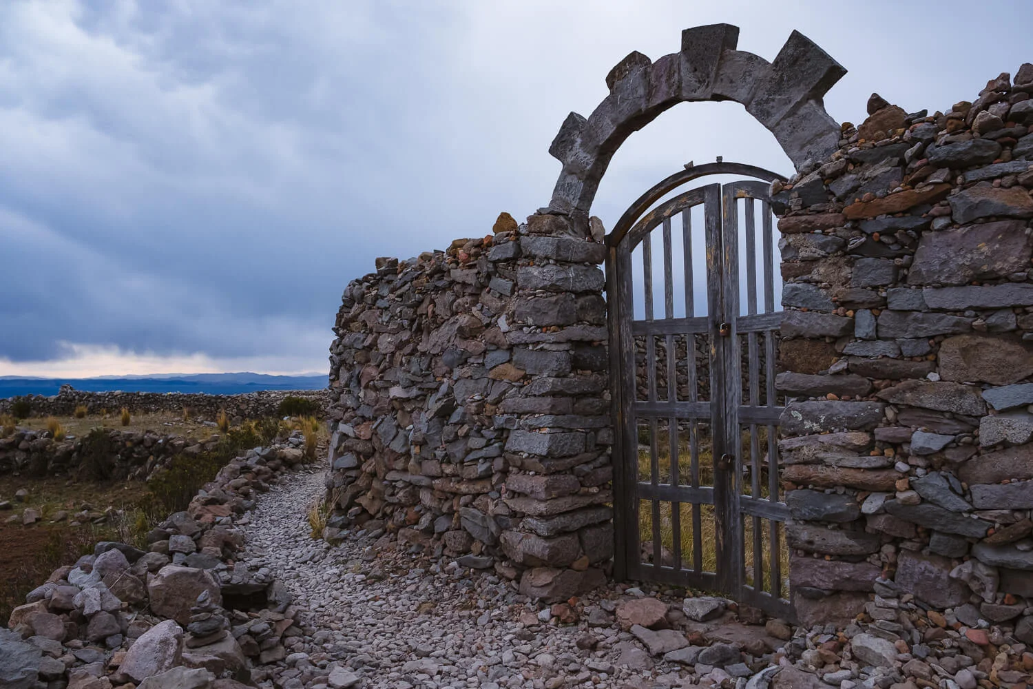 The stone gate at Pachamama, Amantani Island. Travel photography and guide by © Natasha Lequepeys for "And Then I Met Yoko". #peru #laketiticaca #amantani #taquile #homestay #culturalexperience #photoblog #travelblog #travelphotography #fujifilm #travel #travelperu #southamerica #allwaystravel #laketiticacaitinerary #puno #uros #floatingislands #pachamama #pachatata