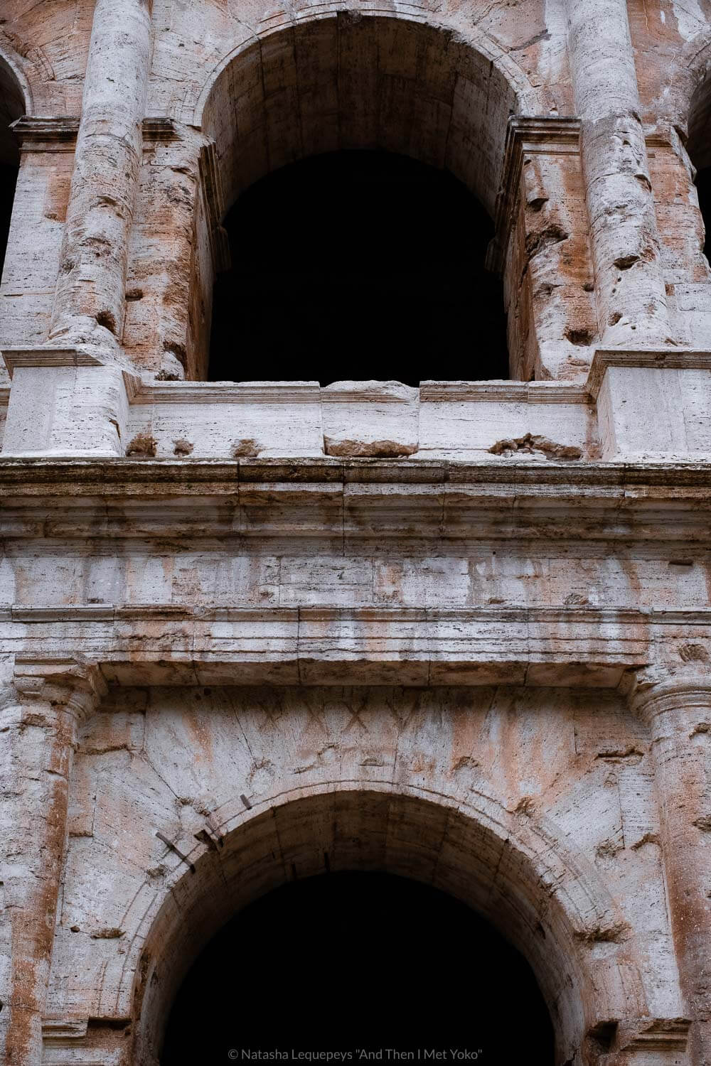 Arches in the Colosseum in Rome, Italy. Travel photography and guide by © Natasha Lequepeys for "And Then I Met Yoko". #rome #italy #travelblog #travelphotography