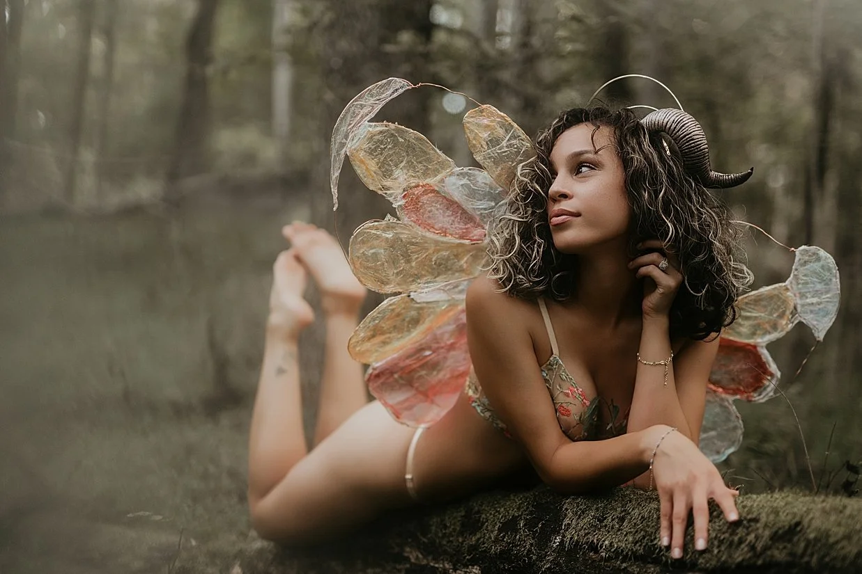 Artistic fantasy photography session of a woman posed in nature with ethereal styling.