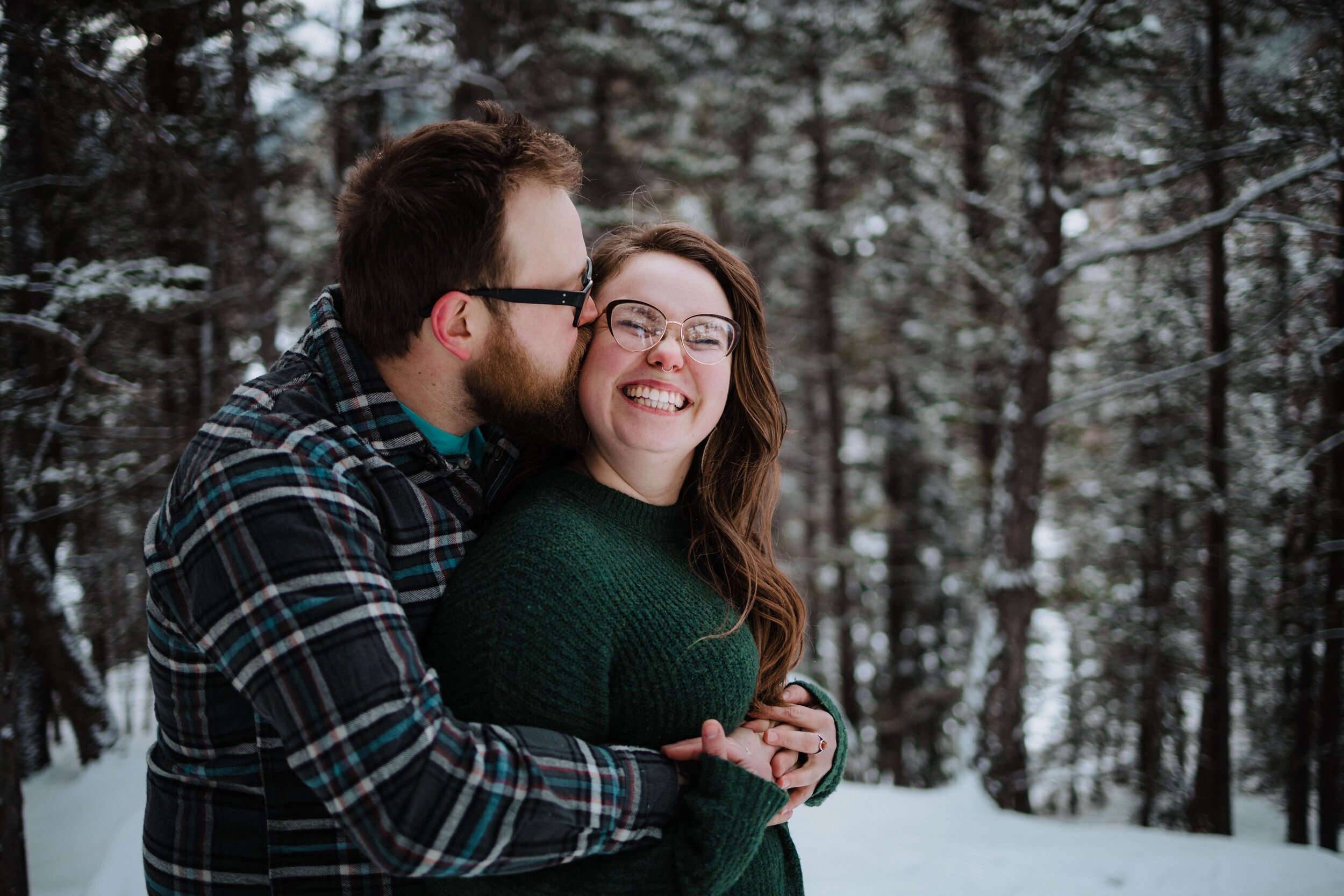 Couple snuggling in Banff National Park