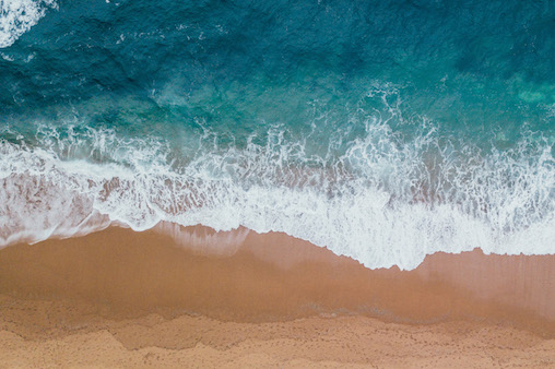 Concept Image: Play Between Sand Beach and Ocean Waves
