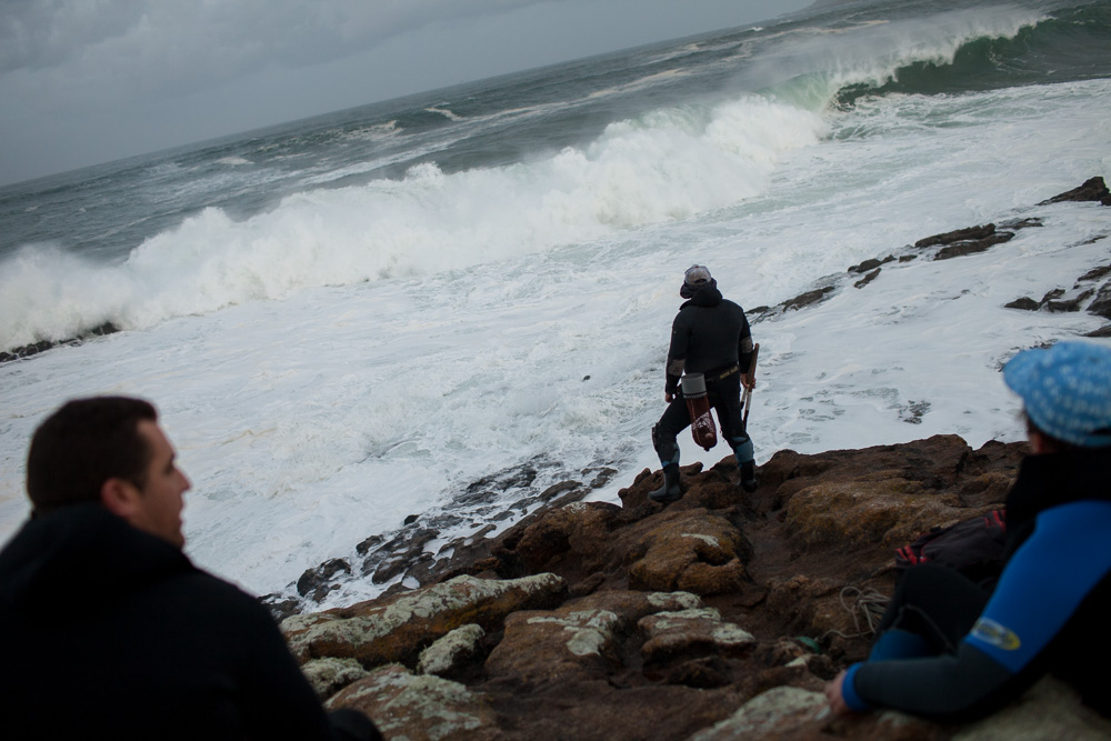 December 12, 2011 - Laxe (La Coruña). Julio looks at the giant waves crashing on the rocks where he's going to fish. Percebeiros have to watch carefully at the condition of the sea, a false step and they could fall into the ferocious current and die. © Thomas Cristofoletti 2011