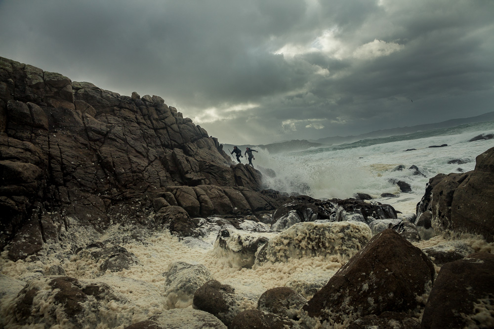 December 15, 2011 - Laxe (La Coruña). Juan and Joaquin, two of younger and skilled percebeiros, try to escape from a unexpected wave. Despite the bad condition of the sea, they decided to go out and harvest anyway. © Thomas Cristofoletti 2011