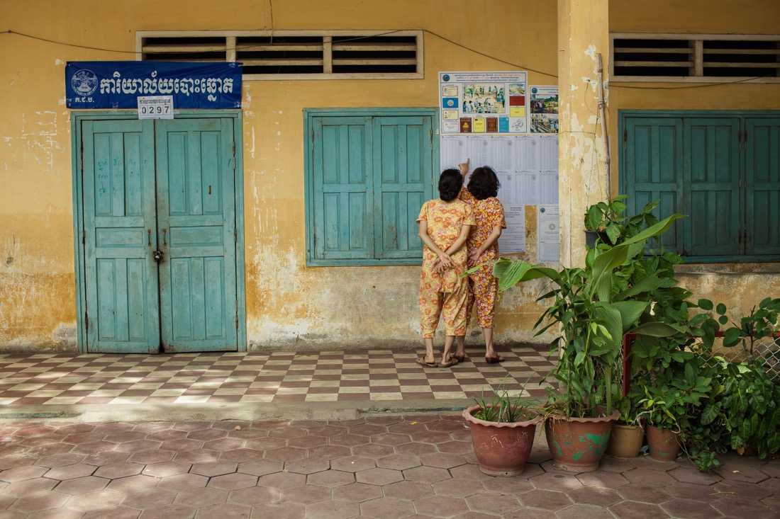 July 27, 2013 - Phnom Penh. Two women check their names on a electoral list in a polling station in central Phnom Penh. © Thomas Cristofoletti / Ruom