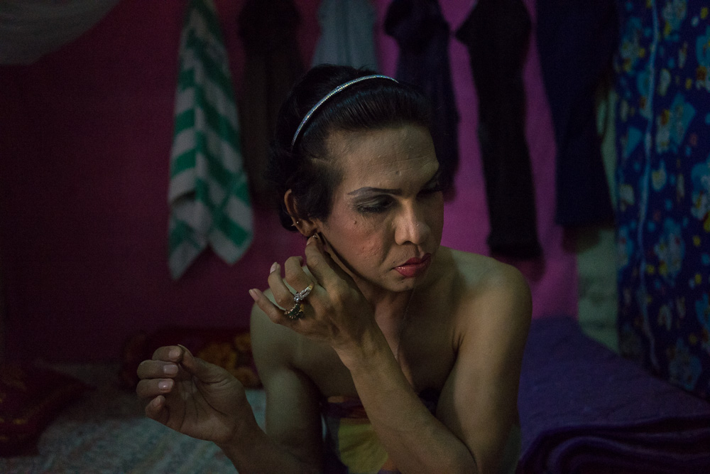 March 22, 2014 - Phnom Penh. A transgender sexworker prepares herself for the night. Contrary to what is happening in neighboring Thailand, the vast majority of transgender people in Cambodia do not have sufficient financial means to afford the cost for sex reassignment and spend a little money in hormonal pills of poor quality and of dubious origin. In many cases, the transition takes place with just a touch of mascara, a cheap foundation cream and some lipstick. © Thomas Cristofoletti / Ruom