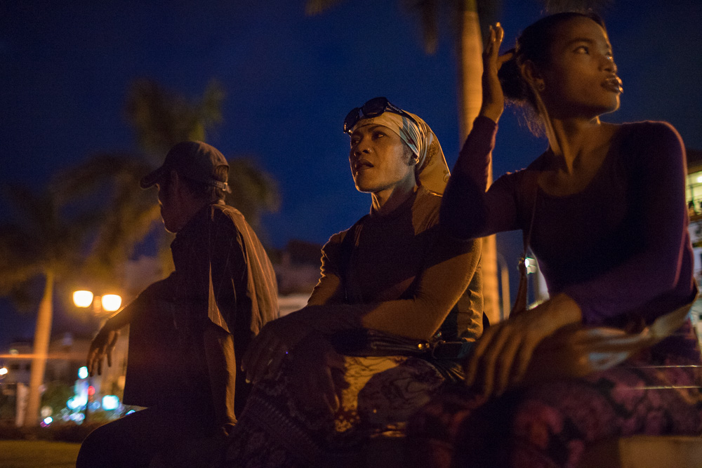 July 13, 2014 - Phnom Penh. Champa talks with a group of sex worker along the riverside of Phnom Penh, one of the places frequented by tourists and "sexpats" of the capital. At the age of 42 years, Champa works for the Women's Network for Unity, an organization that helps Cambodian sex-workers and transgender people. She spends many of her evenings talking and educating them about safe sex. © Thomas Cristofoletti / Ruom