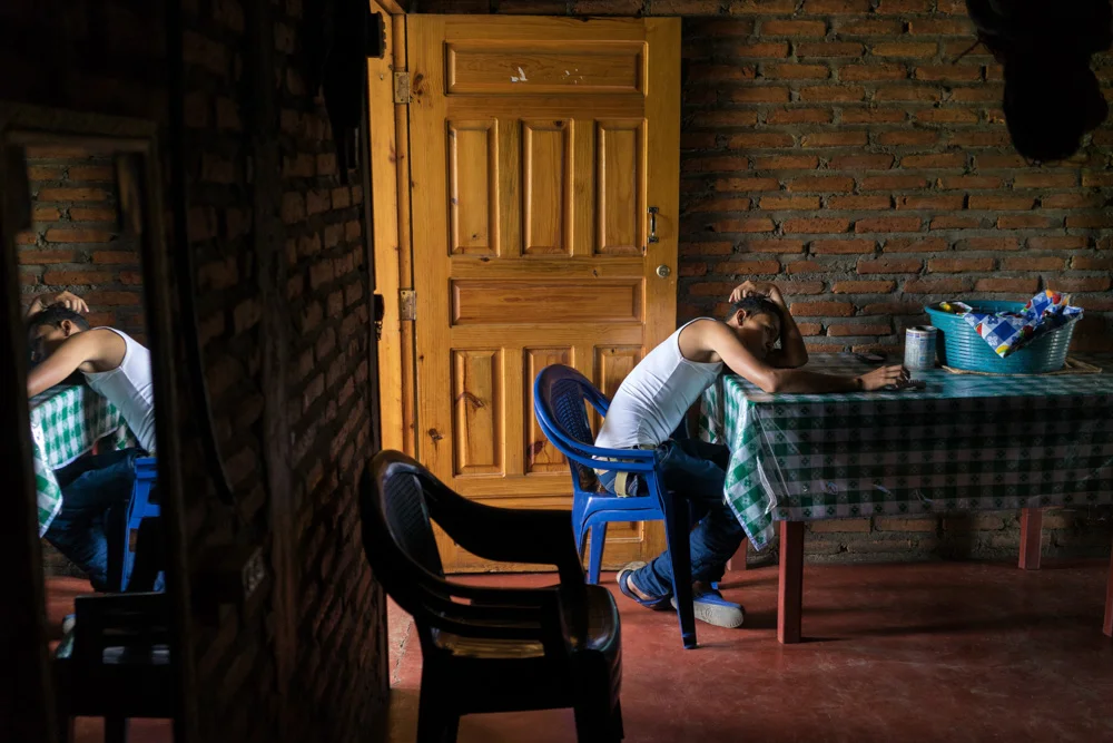 June 23, 2015 - Tegucigalpa (Honduras). Luis Edgardo Cruz Diaz, 15, has a moment of relax at his home in the Nueva Capital neighborhood. Just a year ago, Luis was having trouble at home and he searched for love and acceptance in the wrong places -- eventually becoming leader of the local gang. But after Luis and his family began the USAID pilot program Proponte, his counselor Sabina helped him gradually change his attitude. He left the gang, returned to school, formed positive friendships, and started respecting his mom, stepfather and siblings. © Thomas Cristofoletti / Ruom for USAID