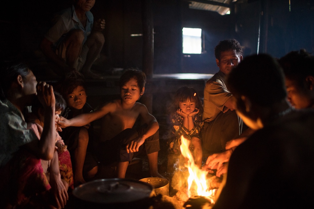 July 29, 2014 - Mondulkiri (Cambodia). A Phnong family sits around the fire inside a traditional house in Busra village. © Thomas Cristofoletti / Ruom 